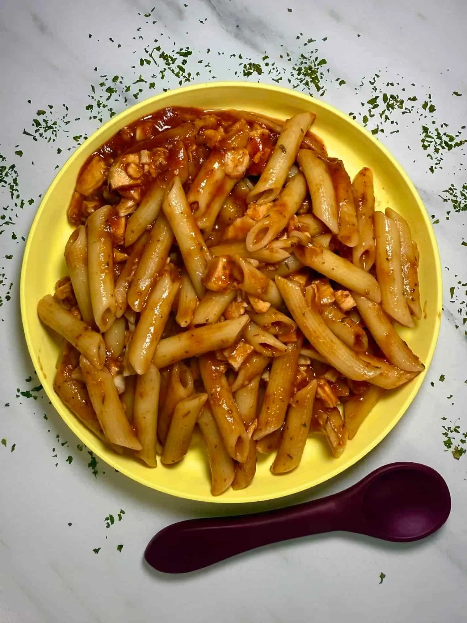 Leftover turkey pasta served on a toddler plate
