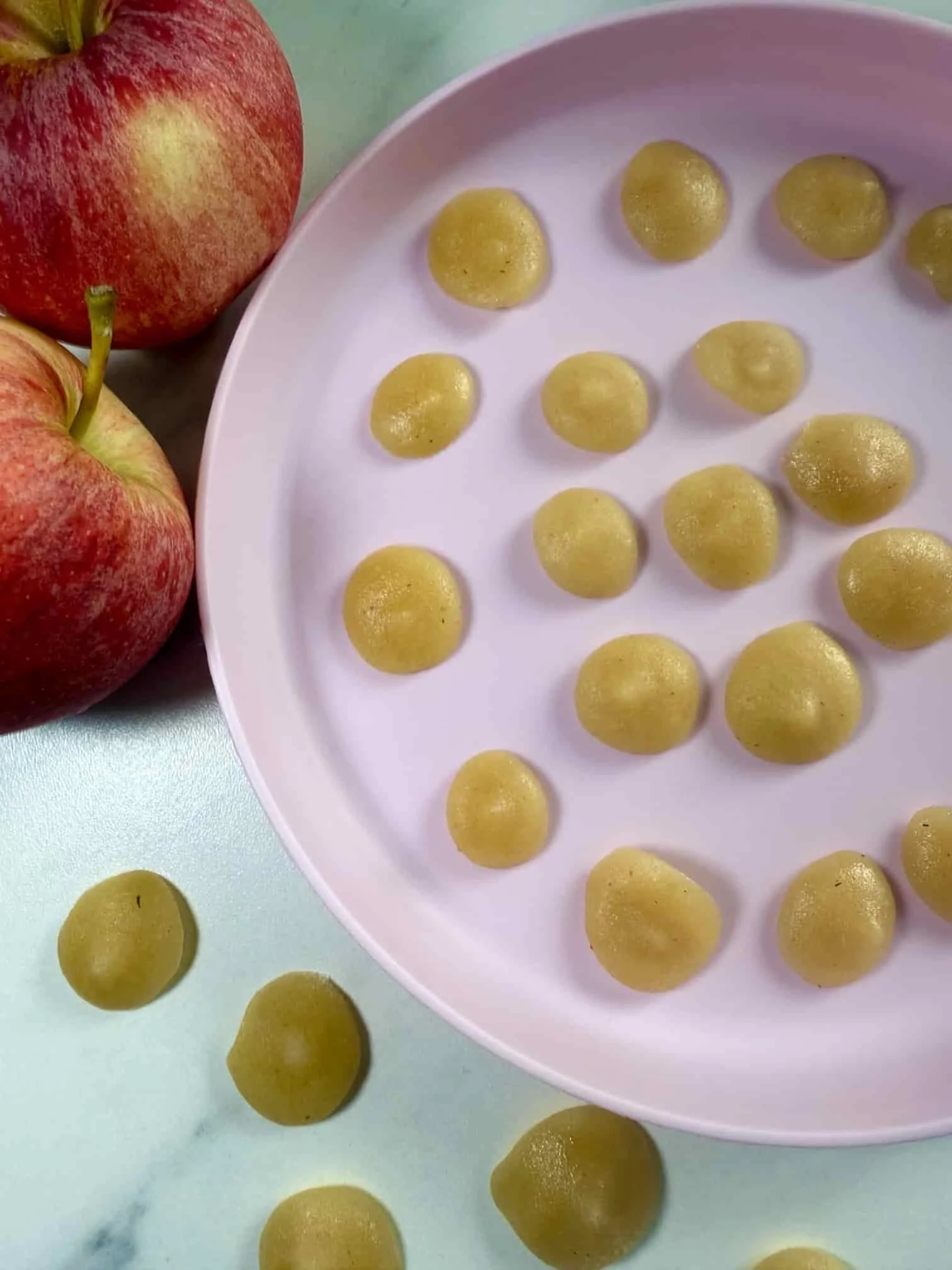 Several bite sized portions of applesauce on serving dish ready for the freezer