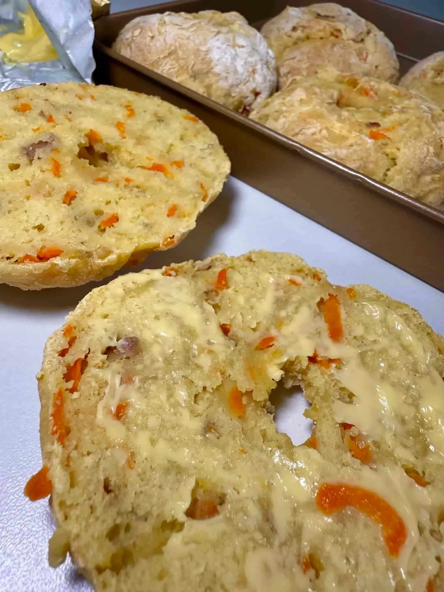 A baked ABC bagel cut in half and spread with butter