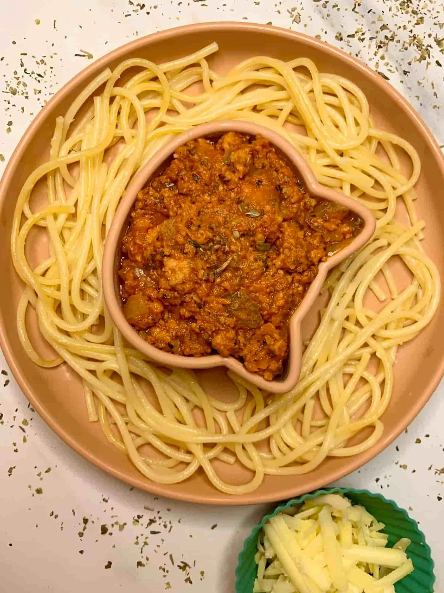 Slow cooked chicken spaghetti served in partitioned toddler bowl
