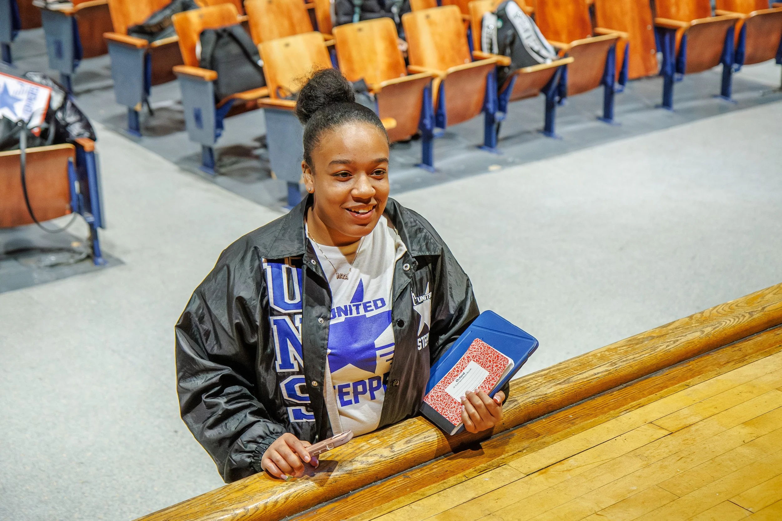 A girl stands near table 