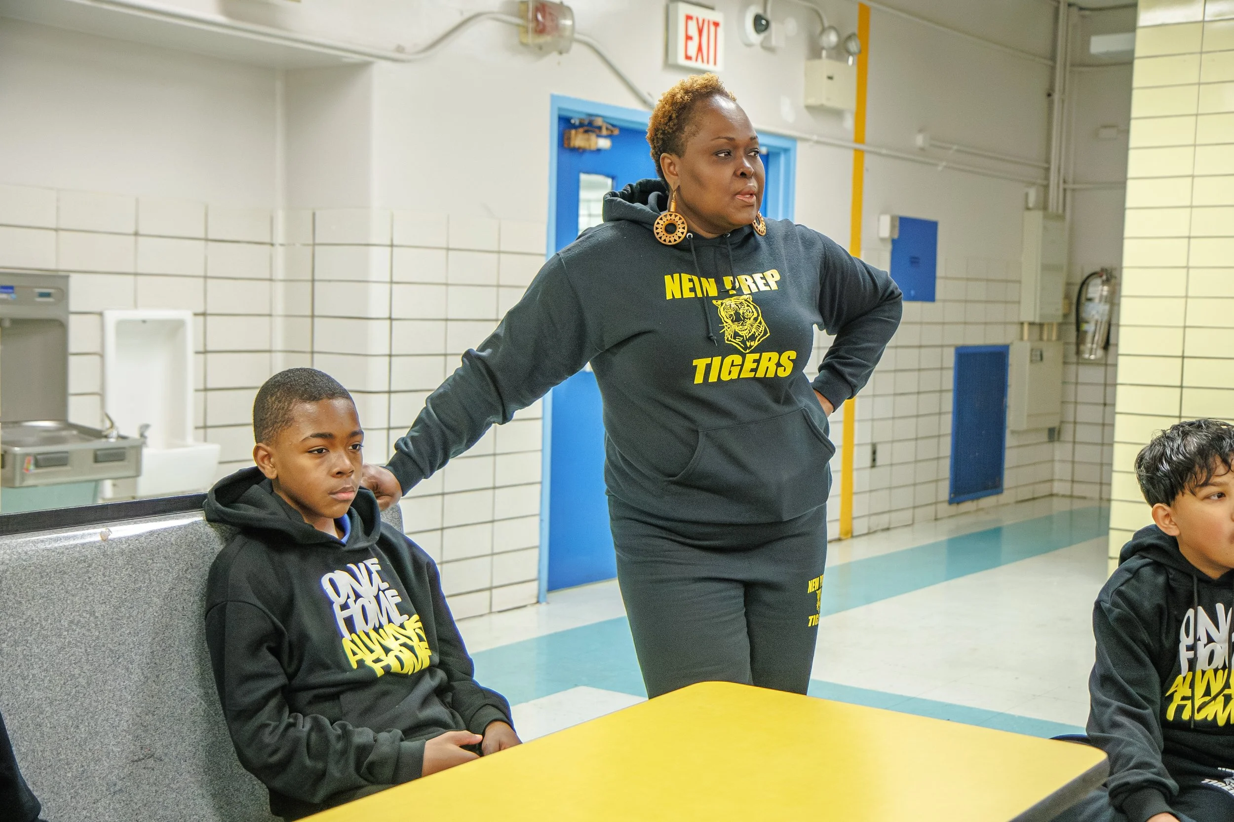 Teacher stand's near student table