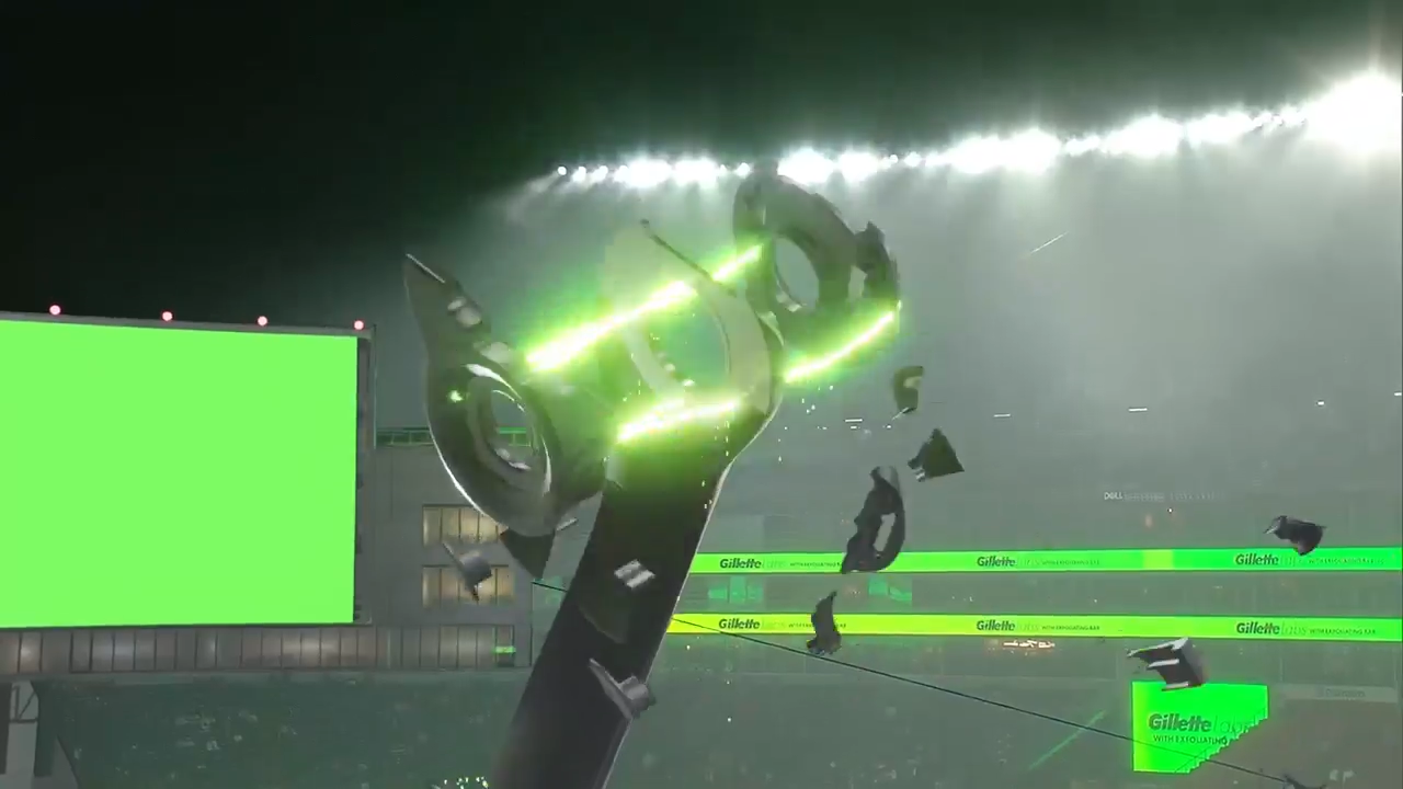 Green and black electric shaver breaking apart with sparks in a stadium scene with Gillette branding, created with Unreal Engine and Pixotope in a real-time virtual production pipeline.