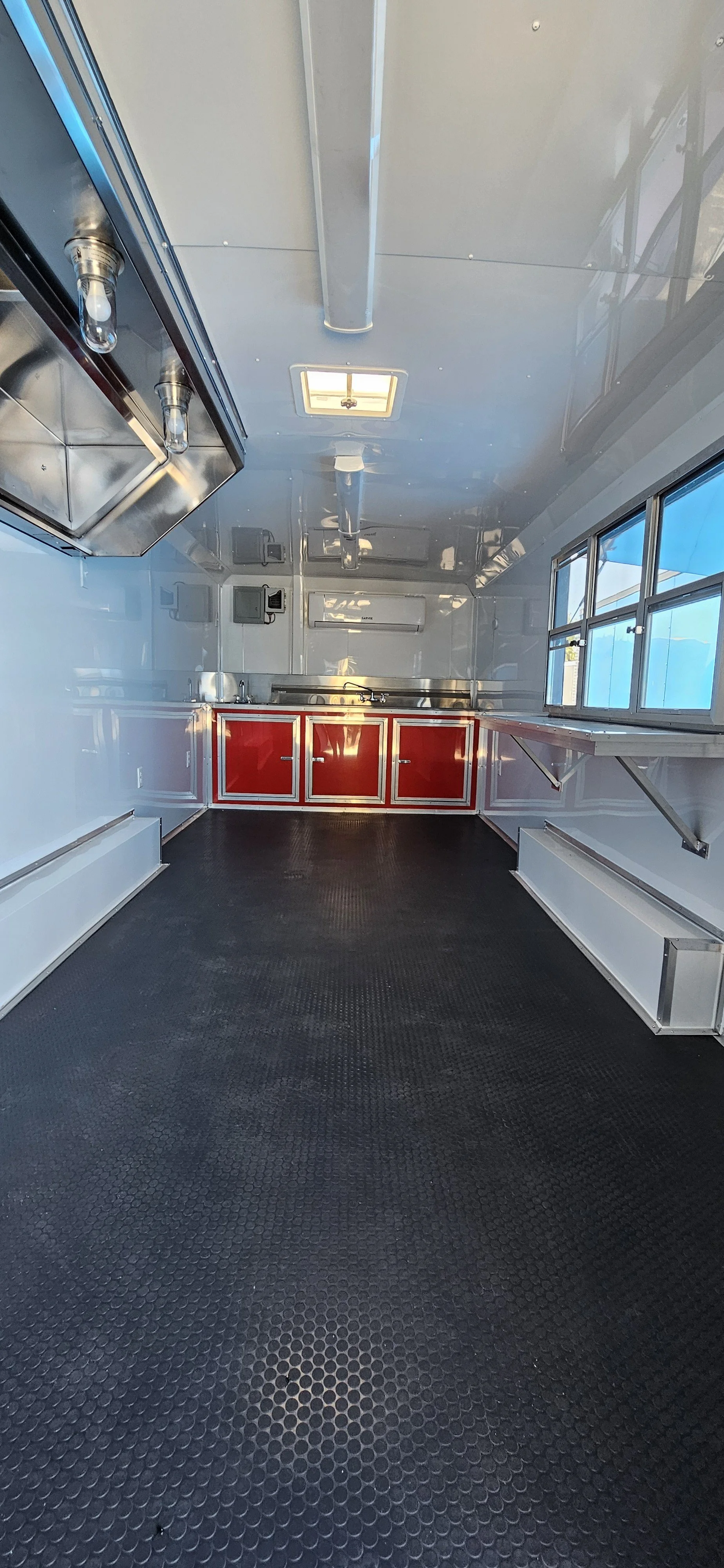 inside of 8.5X20TA3 Red Concession Trailer #70144 with red and white cabinets
