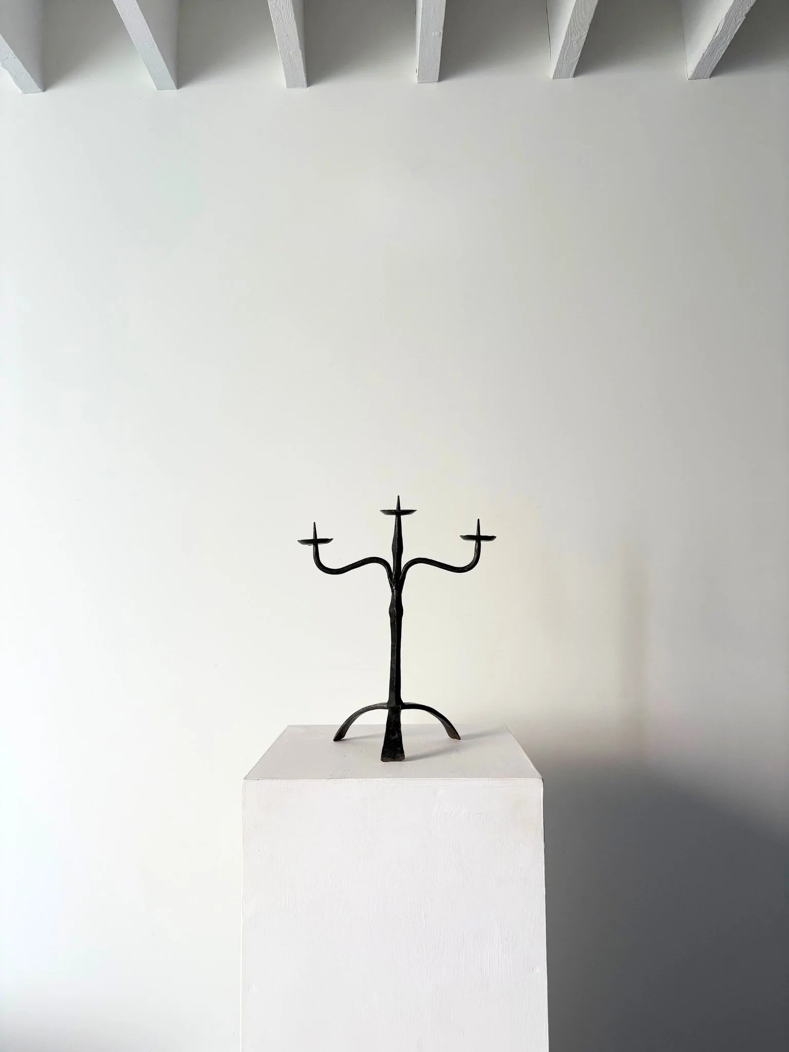 This 20th Century vintage candle holder is hand made in wrought iron with a twisted stem and a sturdy tripod base - Bureau Bruton
