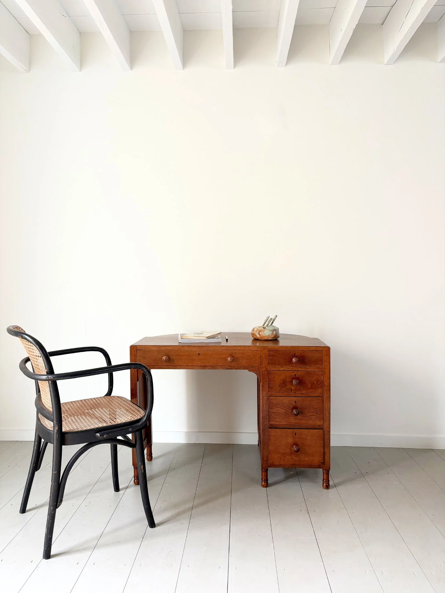 A Naive 20th Century Desk Tidy sits atop an Art Deco Desk by Heals of London - Bureau Bruton