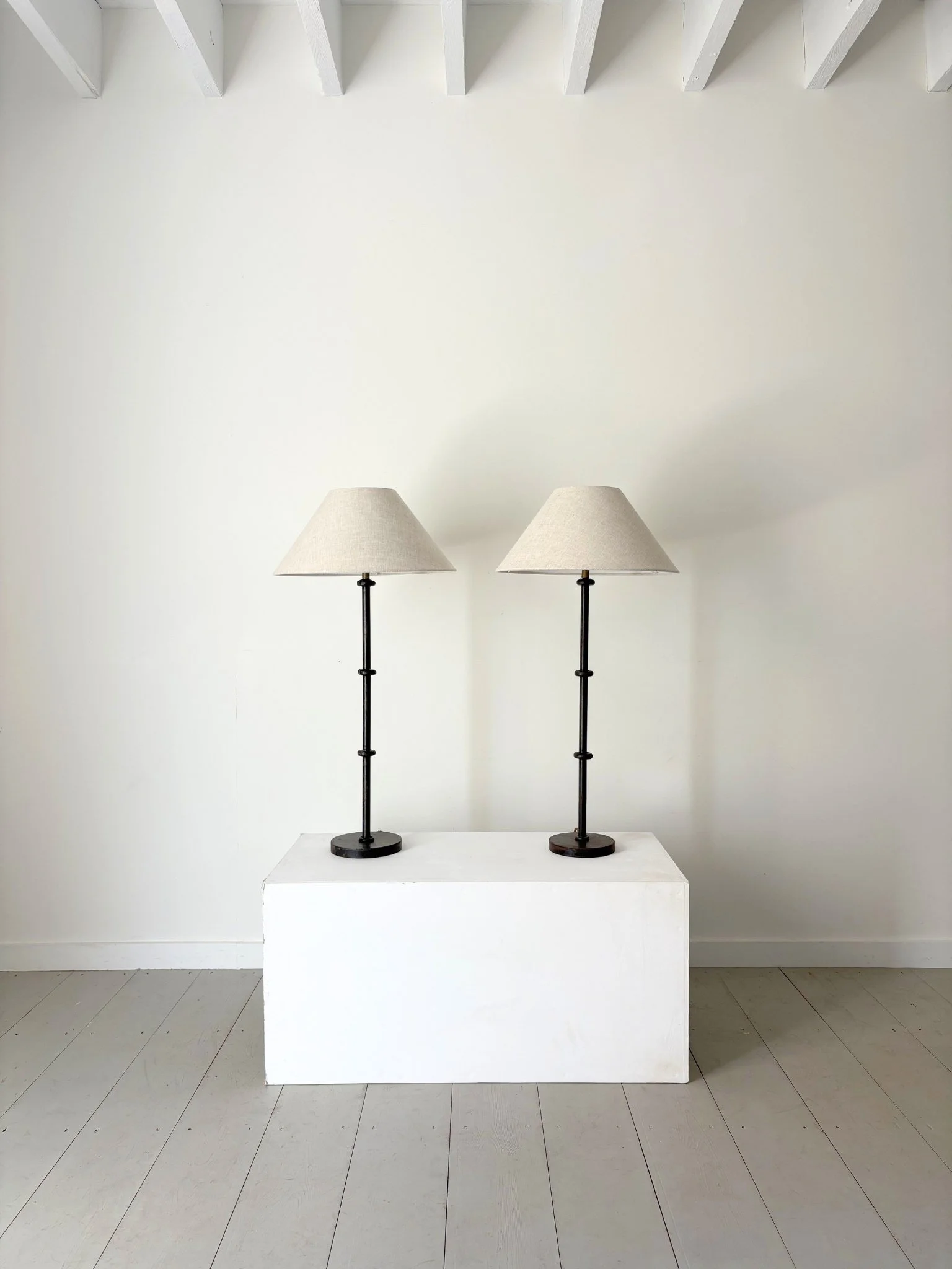 A pair of slim stemmed table lamps in the manner of Jacques Adnet - Bureau Bruton Antiques and Vintage Shop
