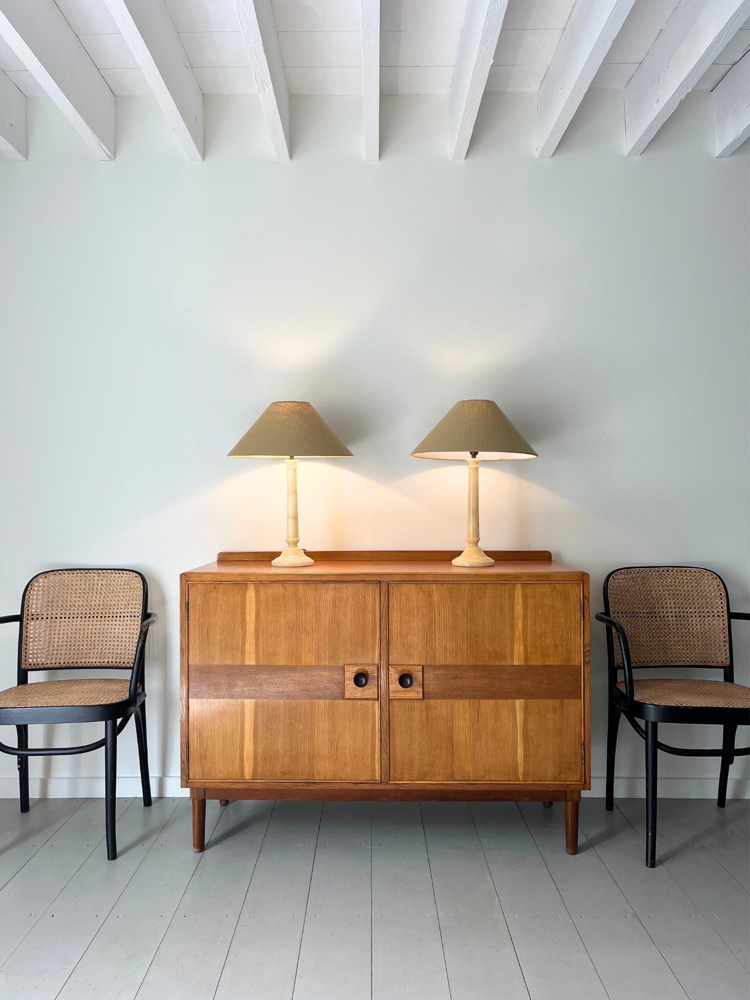 A pair of Spanish alabaster table lamps in a minimal yet classic column design, sitting atop a Mid Century inlaid sideboard - Bureau Bruton