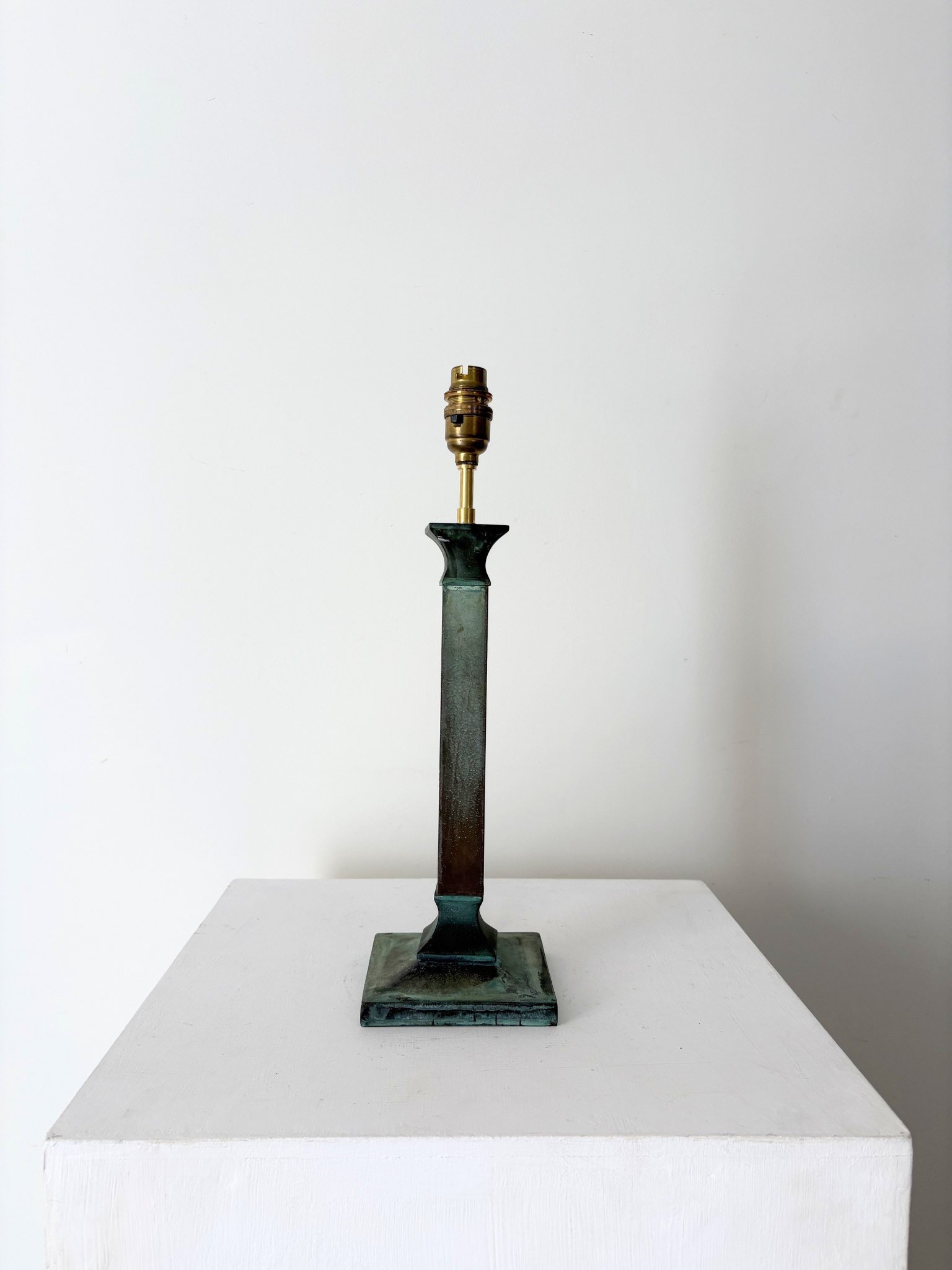 A neoclassical table lamp with a squared column stem sitting on an elegant fluted base - Bureau Bruton Antique and Vintage Lighting