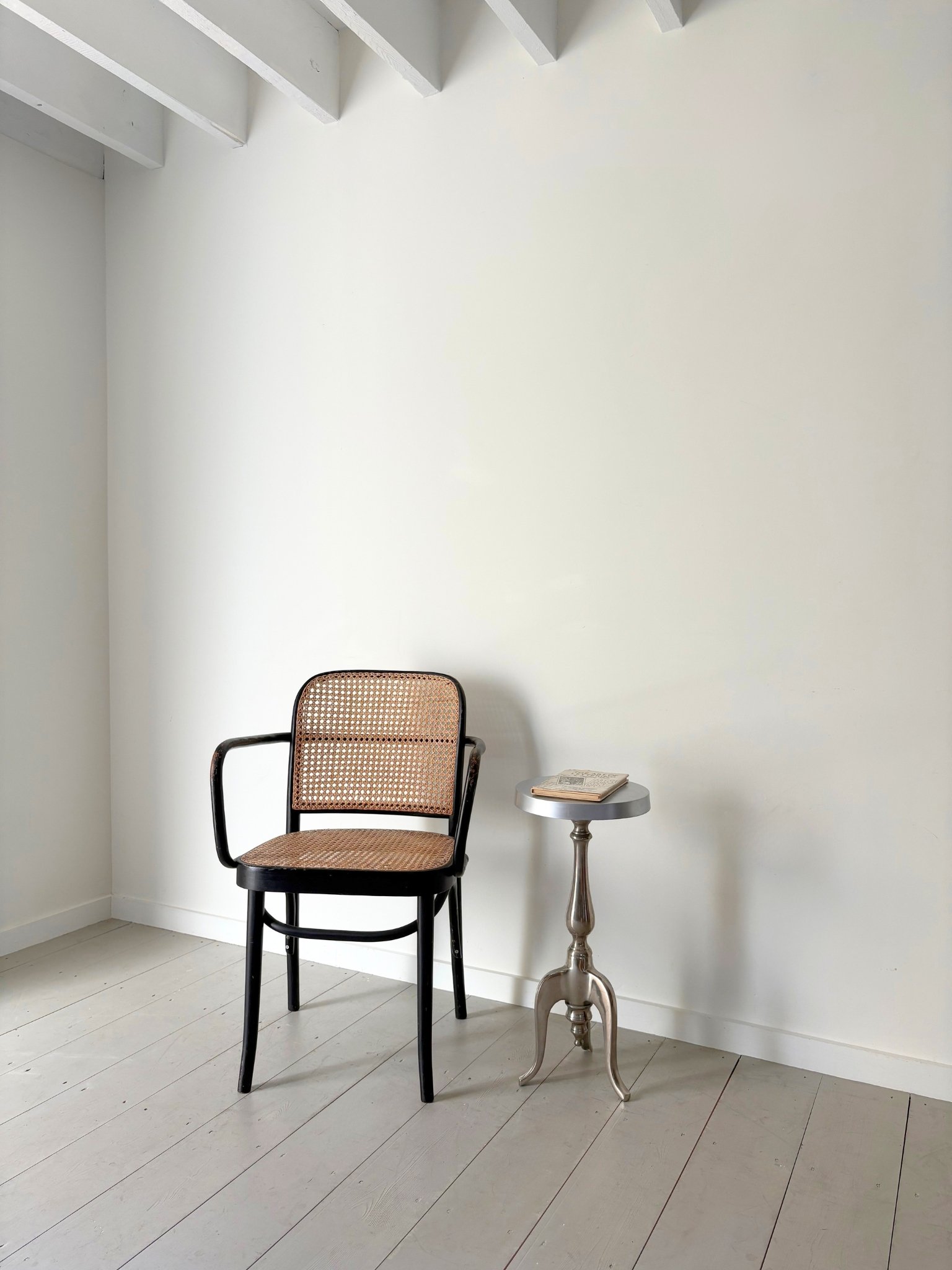 A striking French side table in cast aluminium with a distinctive tripod base featuring arched and scrolled feet. - Bureau Bruton