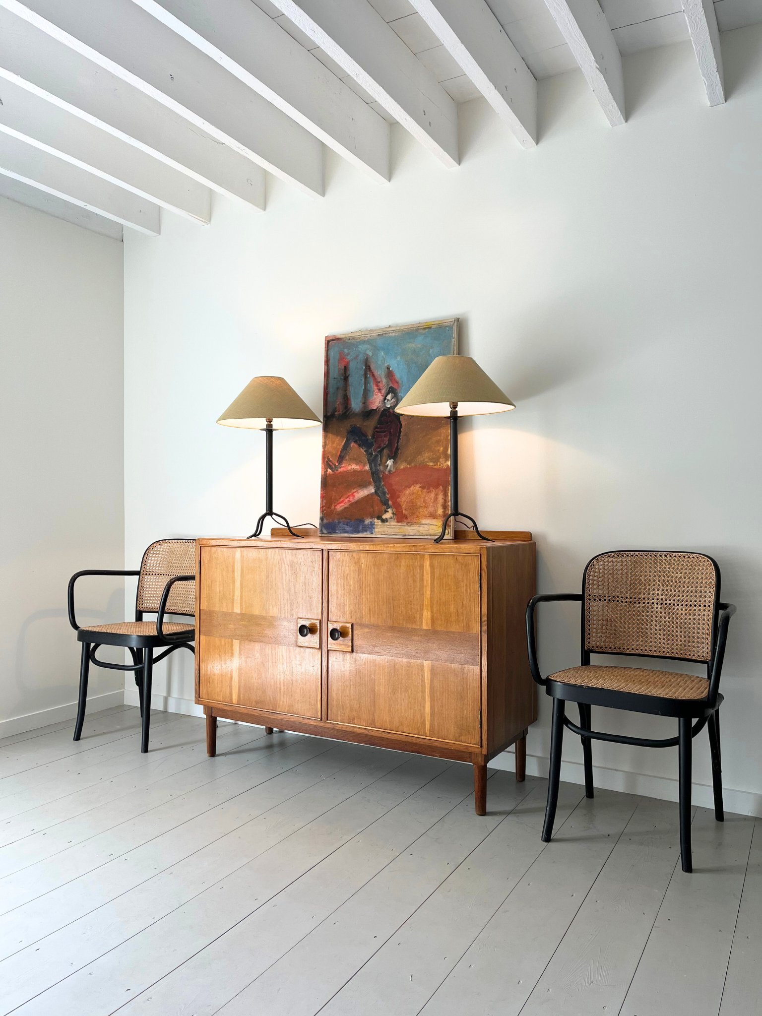 An original 20th century oil on canvas sits atop a striking and large Mid Century sideboard with tonal instarsia inlay - Bureau Bruton