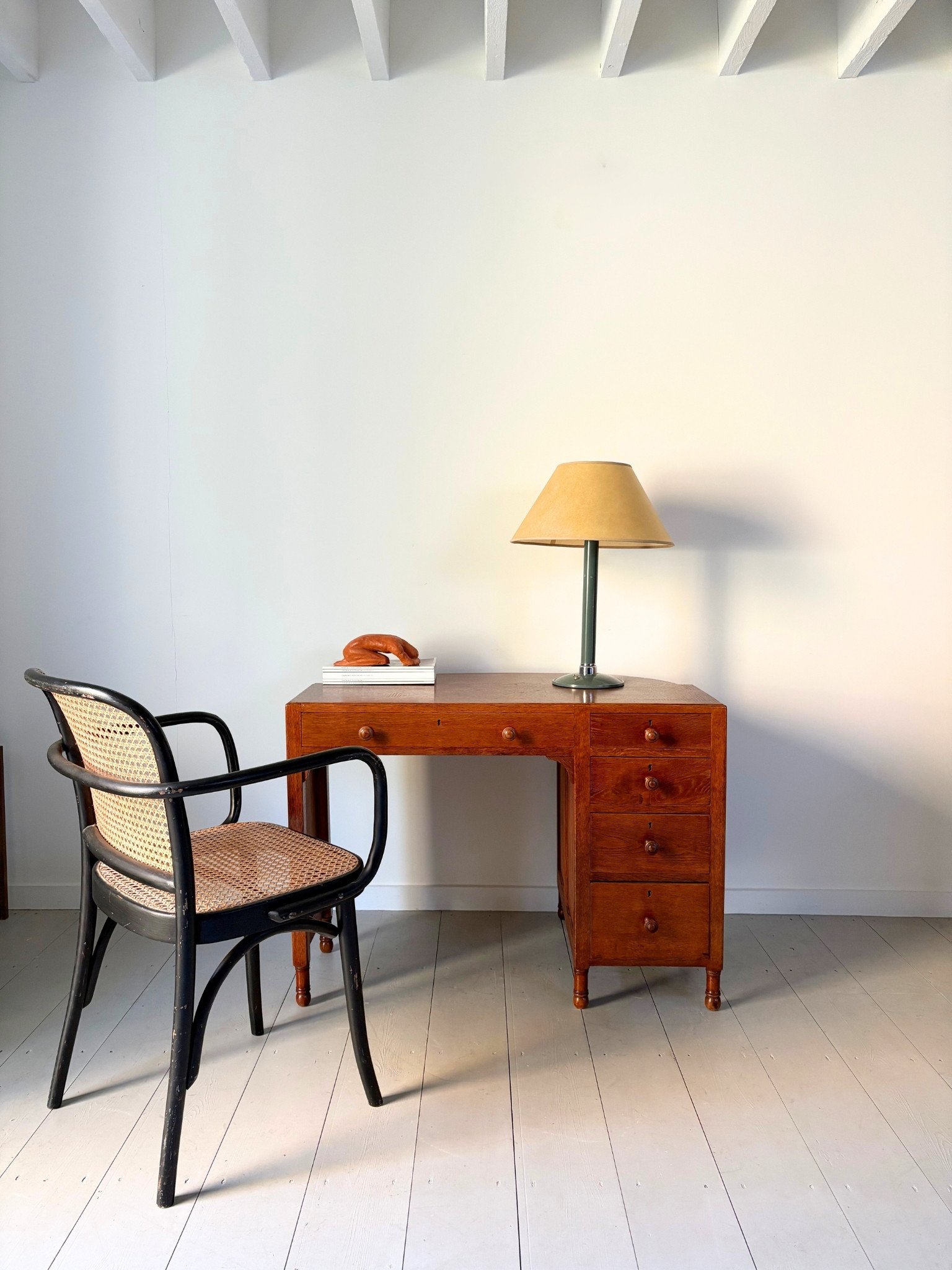 An Industrial Modernist Lamp In Teal Metal sits atop this 1930s vintage Heals Writing Desk, both on view at the Bureau Bruton showroom