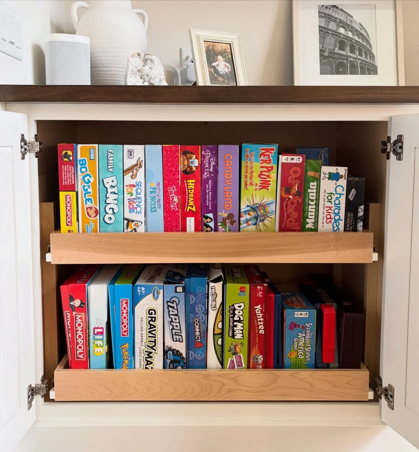 This family is big on board games, so when it came to organizing their stash, we were strategic about putting games for the younger child up top, and those geared toward the older child on the bottom. My client had been storing them vertically like a