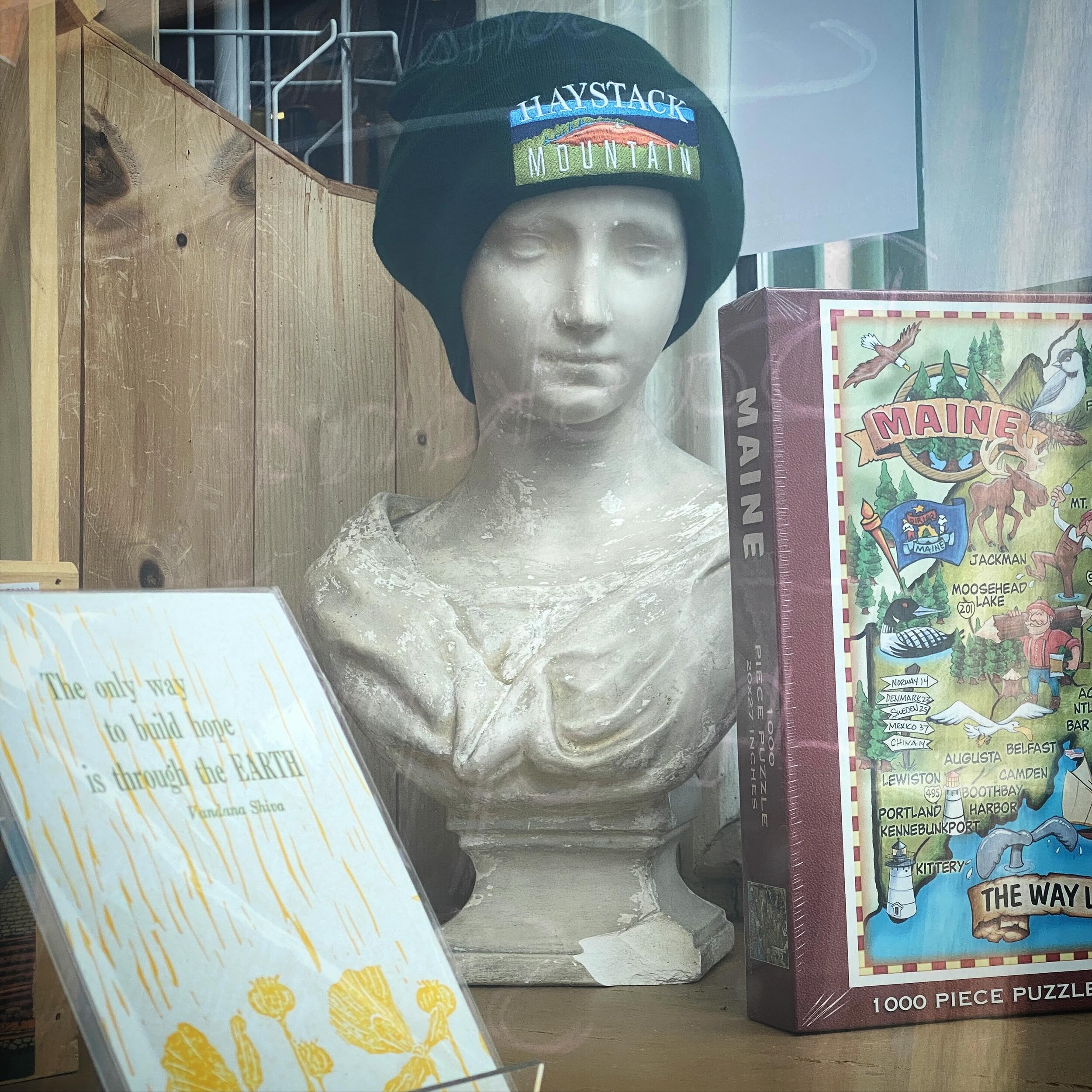 How cool to see the #haystackmountain hat I designed for @friends.of.haystack in the front window of @thegreenstore.belfastme today!
