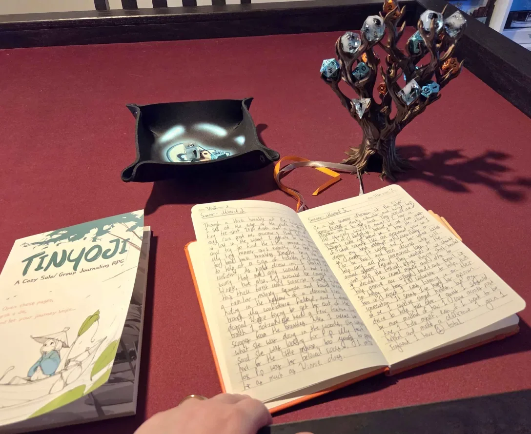 notebook-and-dice-tree-open-to-play-a-game-of-tinyoji