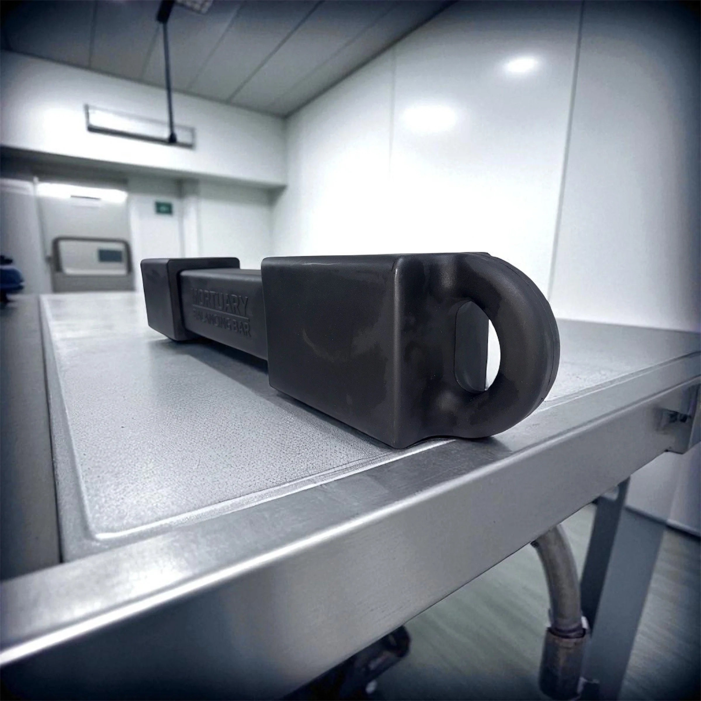 A black handheld portable video scoring bar with the words "PORTADY" and "SCORING BAR" are embossed on the side, resting on a stainless steel table in a clean, sterile room.