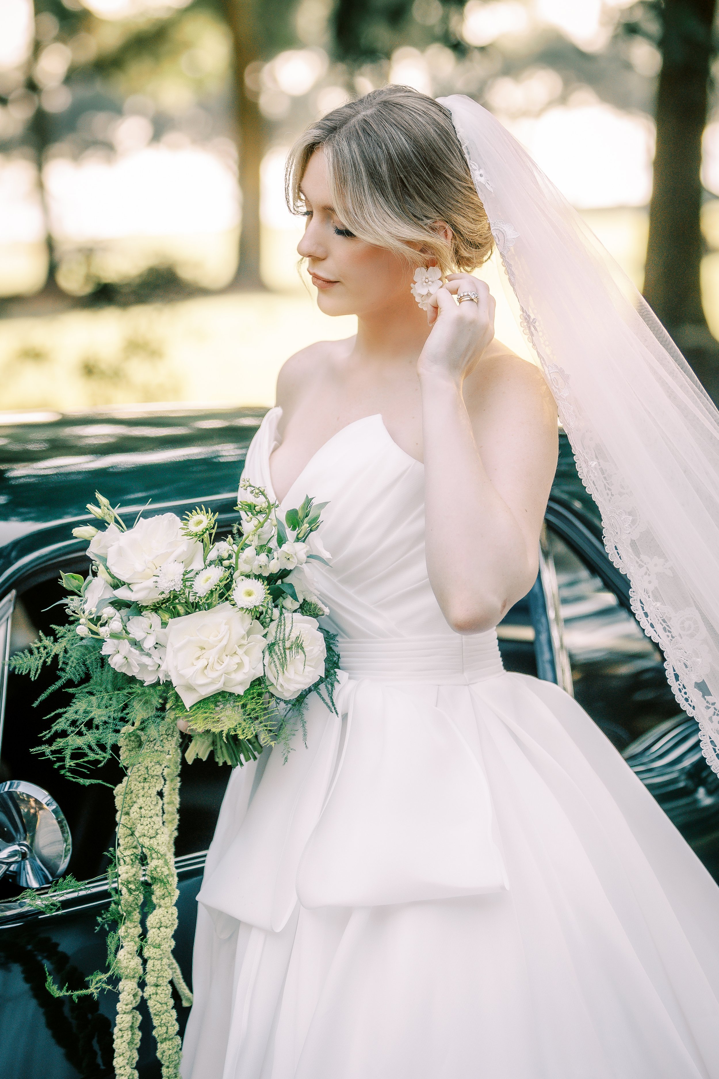 Bride holds white and green wedding bouquet