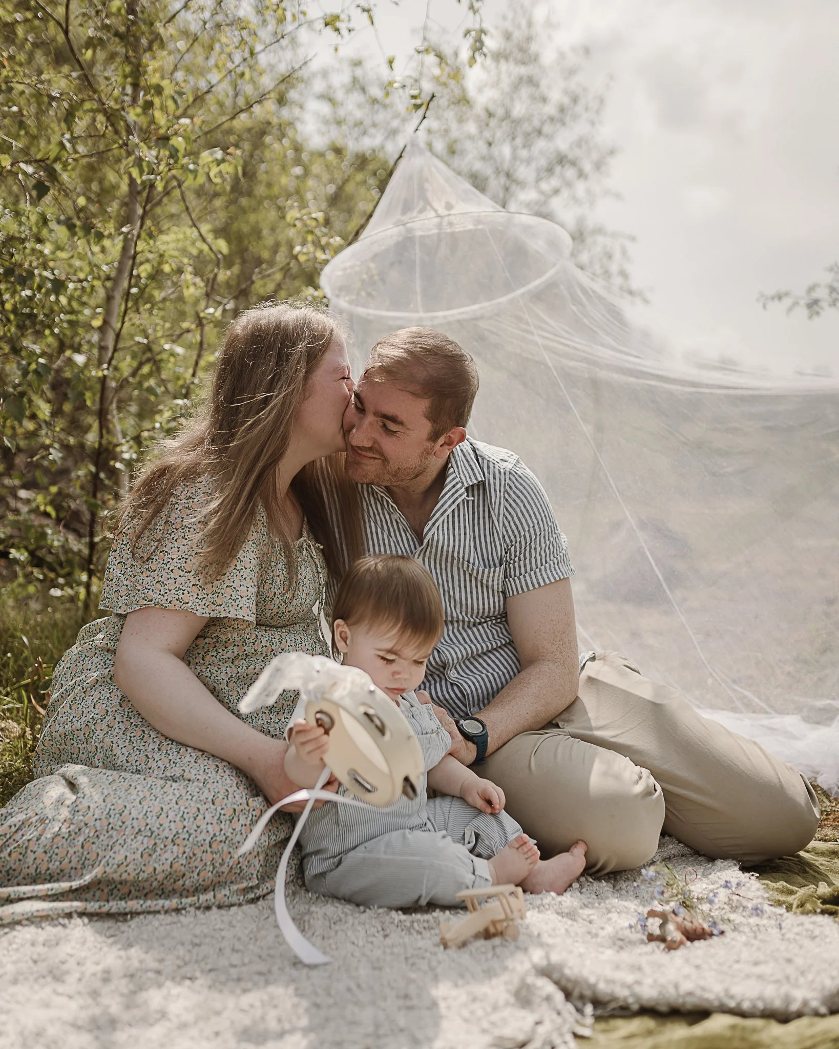A family enjoying a moment together on a picnic blanket at Trowbarrow Quarry