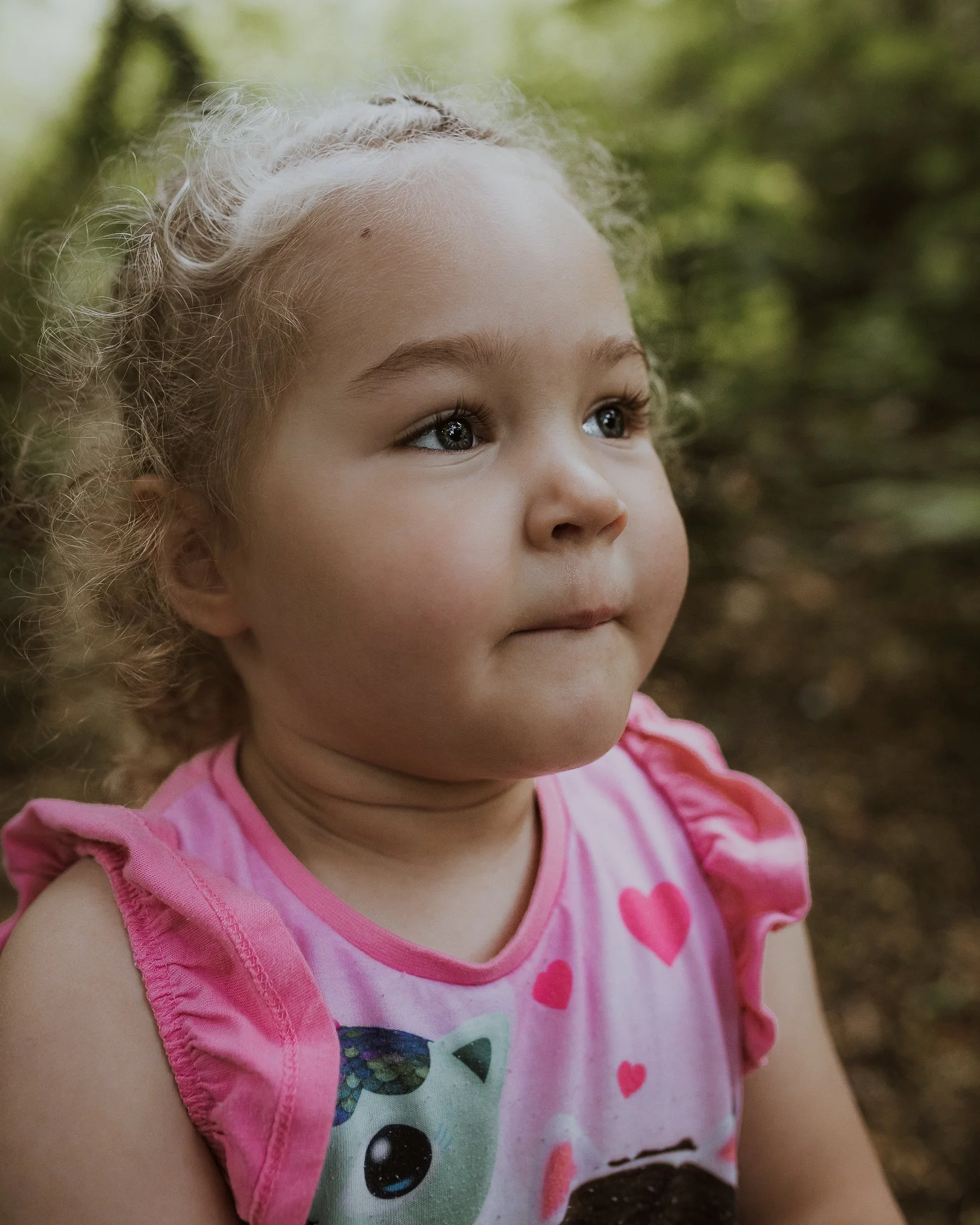 Portrait of a young girl against the forest backdrop at Williamson Park
