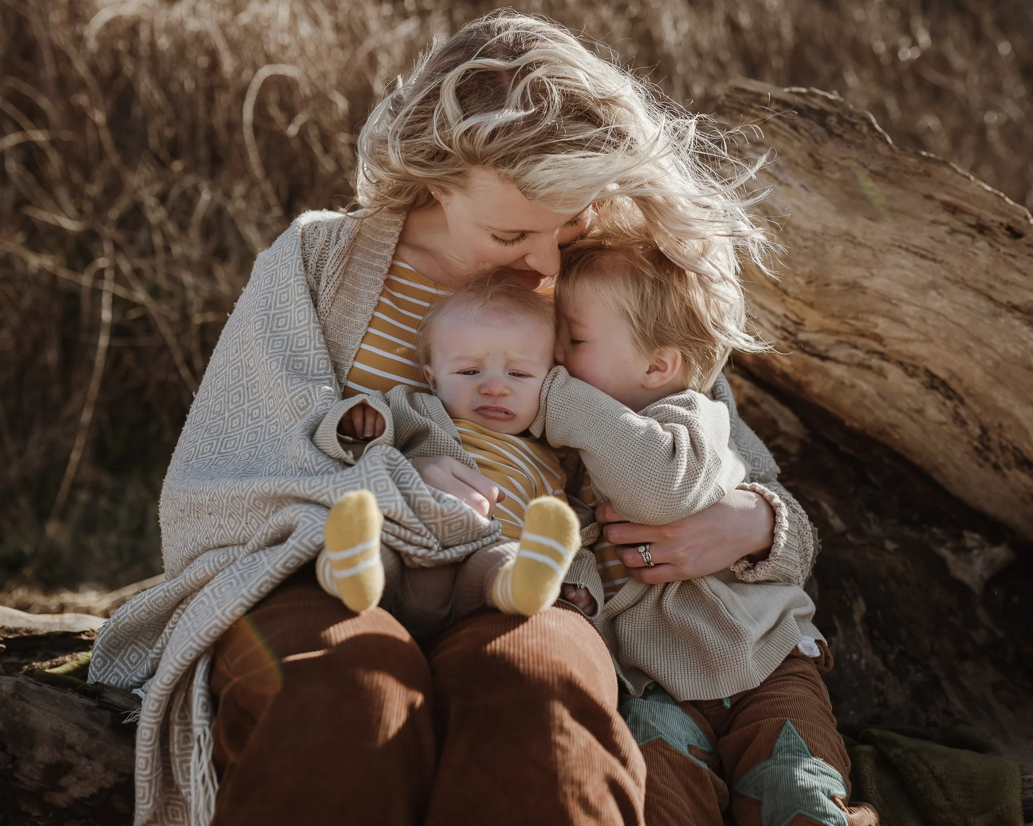 Photograph of a mother with her two boys at the beach