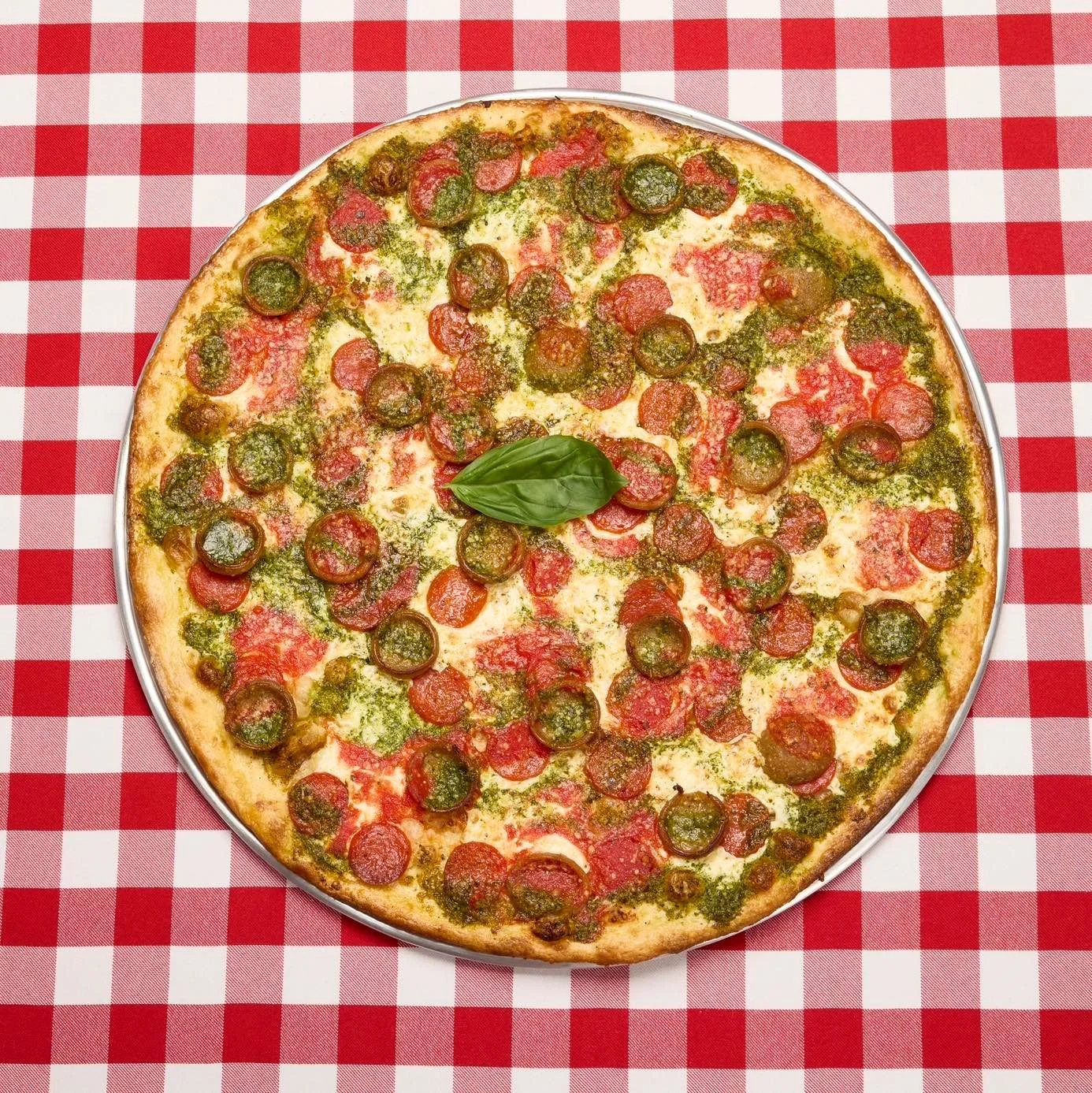 Happy National Pizza Day! 🍕🍕 Celebrate at @grimaldispizzeria with The Duo: Two sauces, two meats, too incredible! It&rsquo;s their traditional pizza featuring both their famous tomato sauce and pesto sauce, topped with pepperoni and spicy cup &lsqu