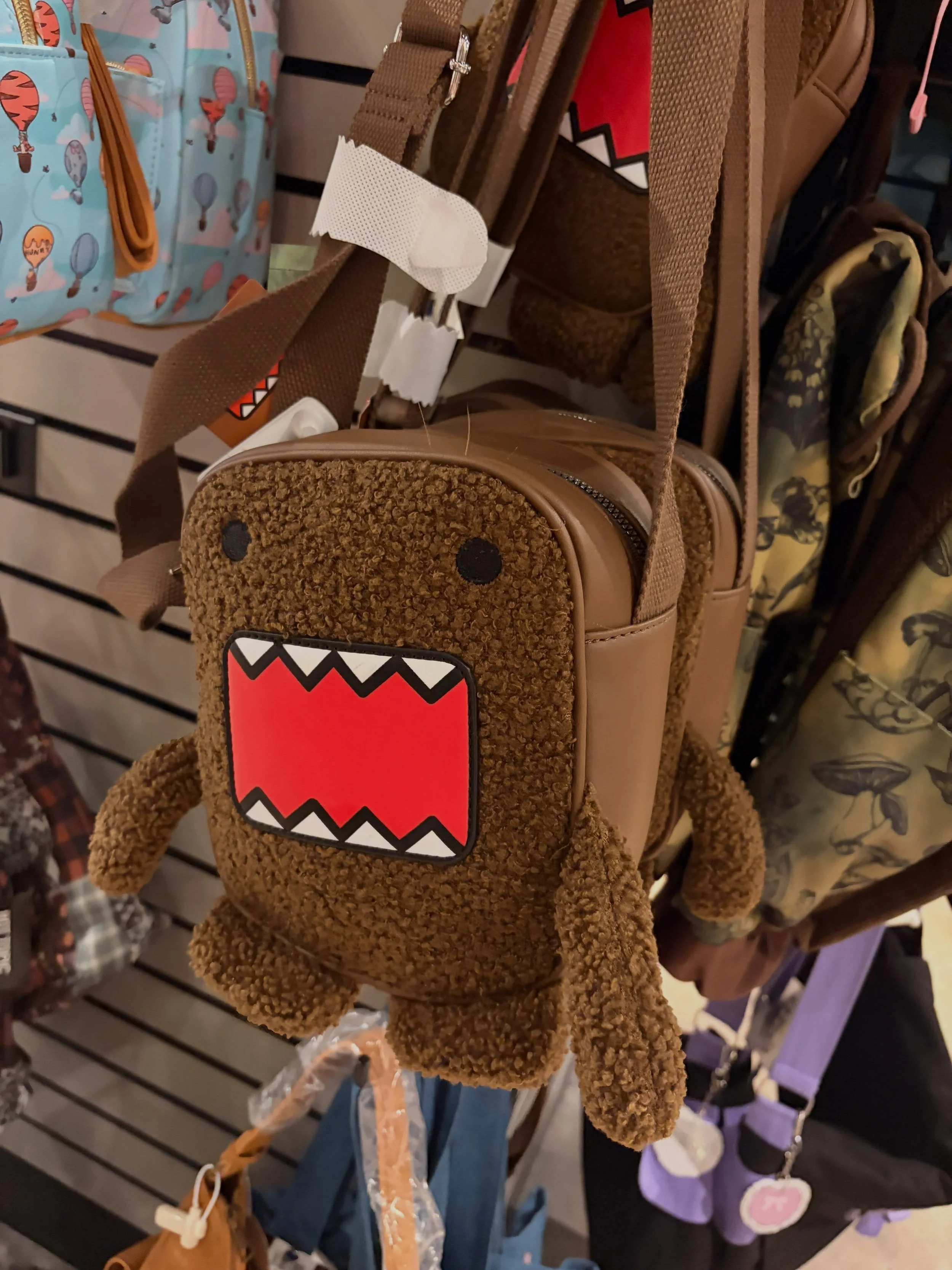 Domo-Kun on bags, sweaters, and arm warmers. Available at @hottopic at La Palmera.