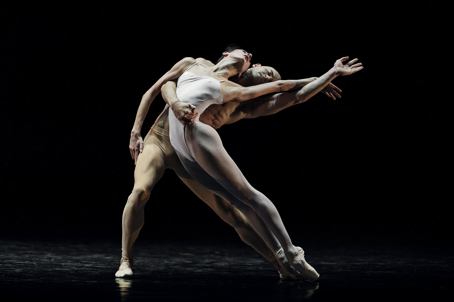 Ballet couple embracing passionately with eyes closed in ballet pose on stage | Mahlers 3. symfoni.jpg