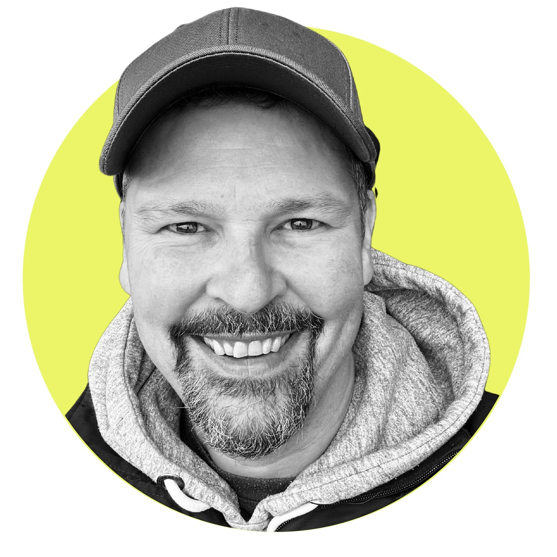 Close up cropped image of smiling man wearing a baseball cap with a yellow background.