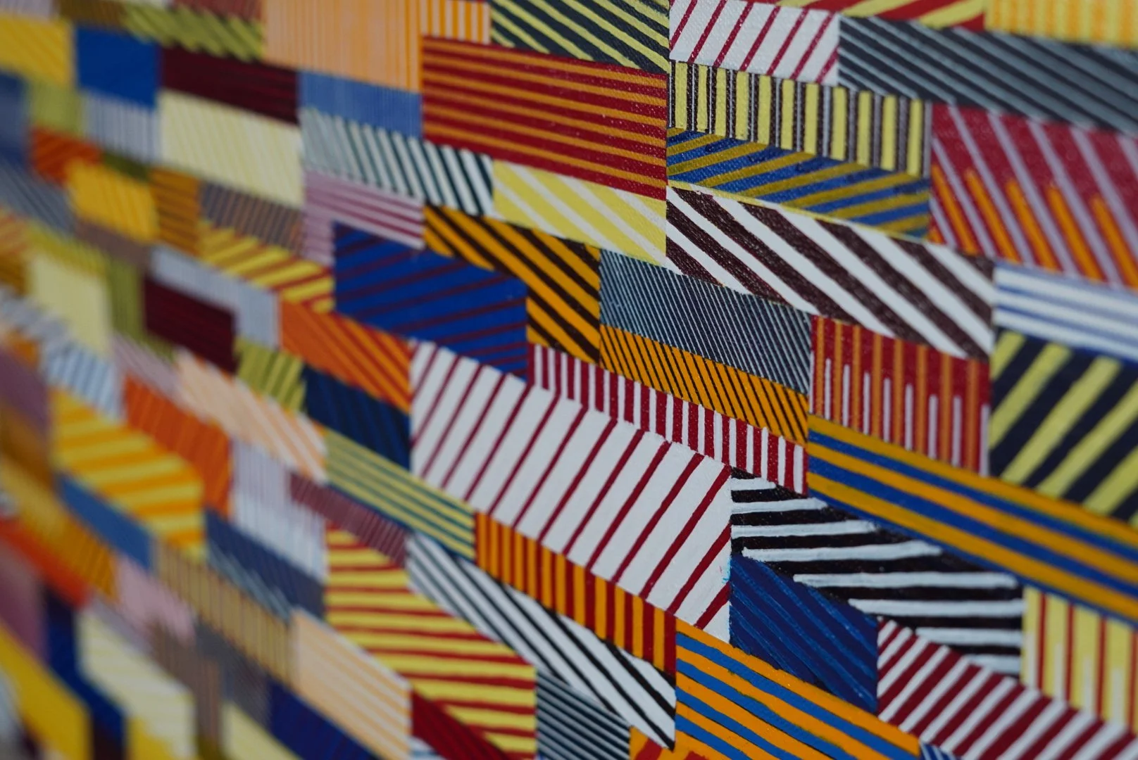 Close-up of Rumination: Chaos Theory by Amylynn Burns, showing colorful geometric cells filled with hand-painted lines.
