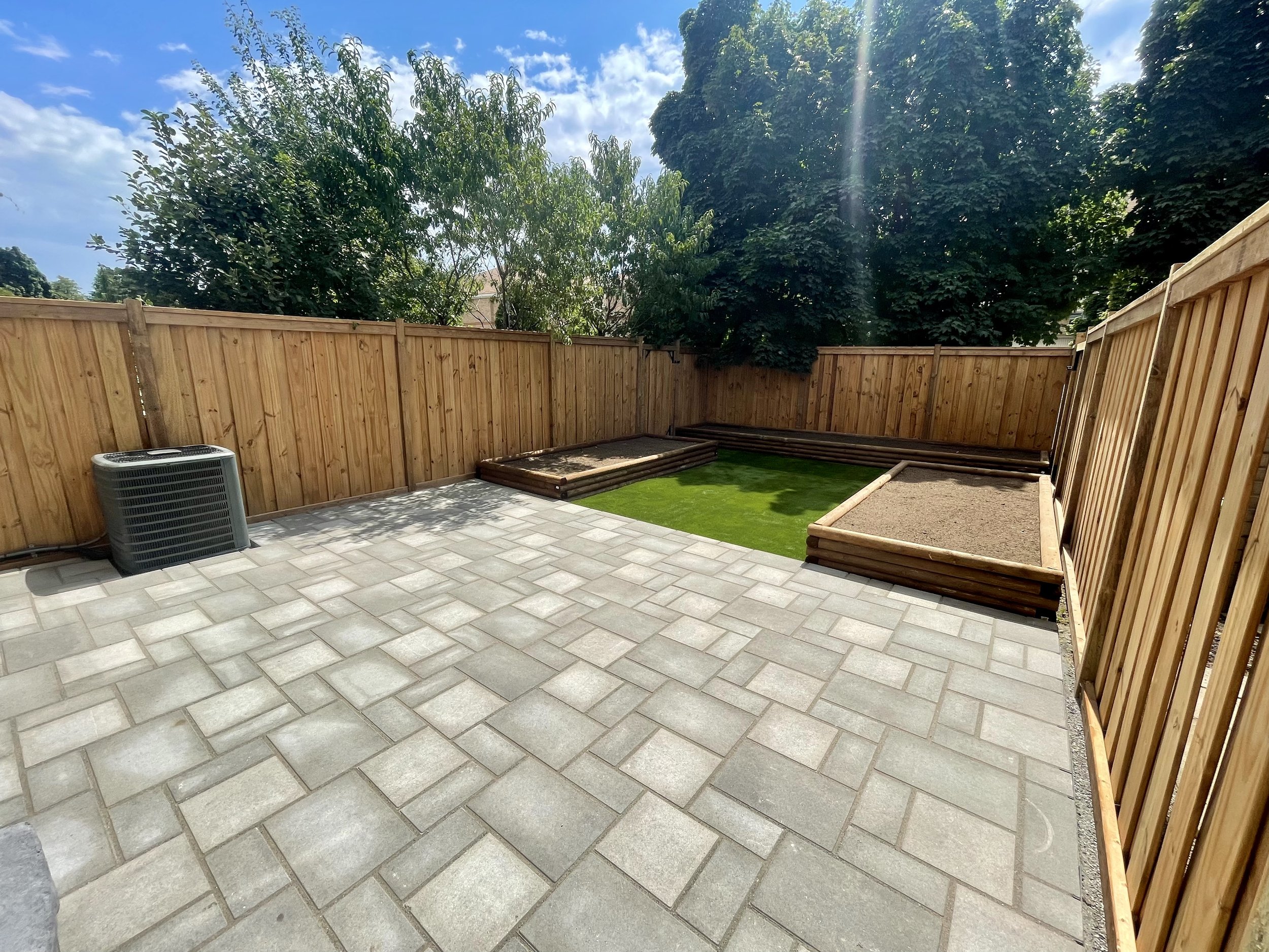 backyard-interlock-patio-raised-garden-beds-artificial-turf