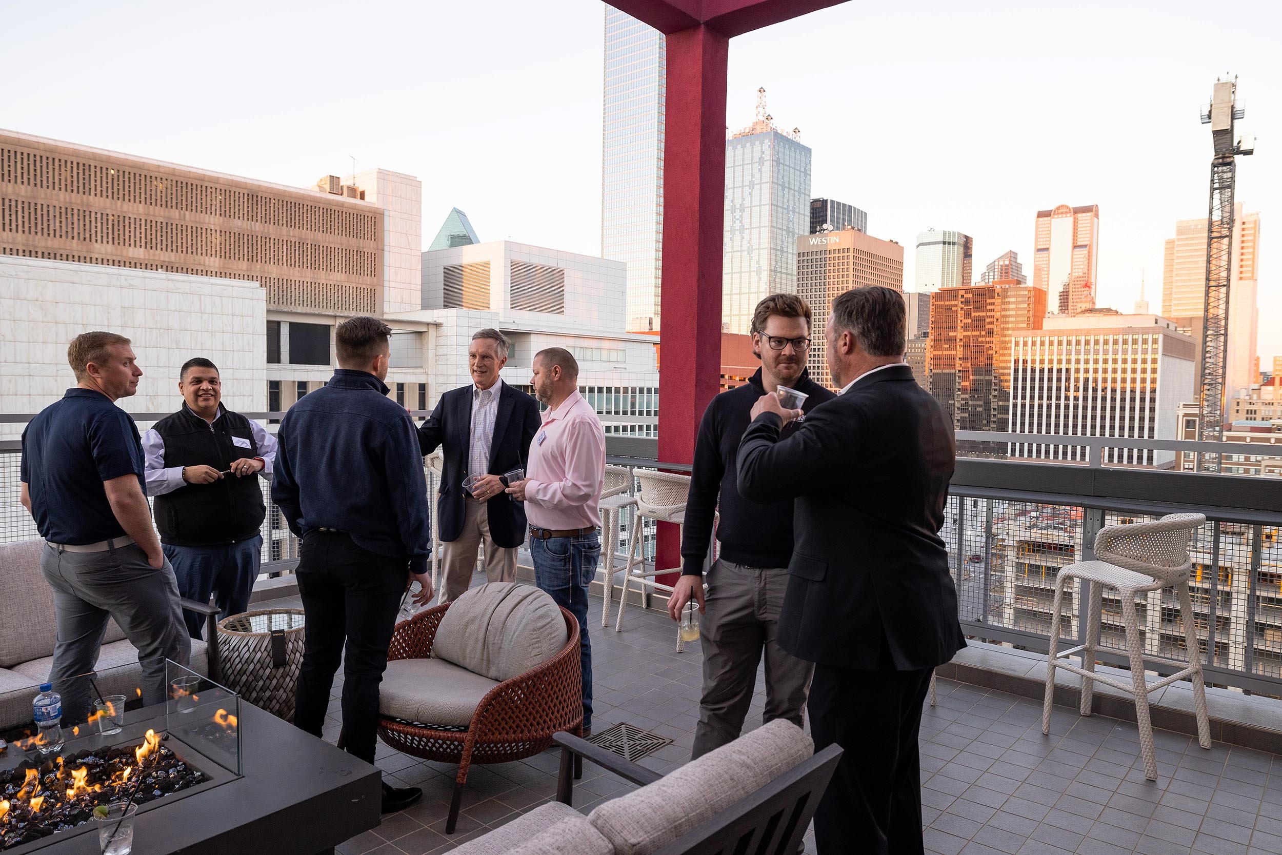 Men gathered an an outdoor cocktail event