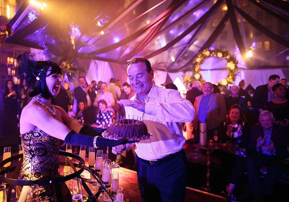 Guests enjoying a vibrant party with colorful lighting, drinks, and lively interactions.