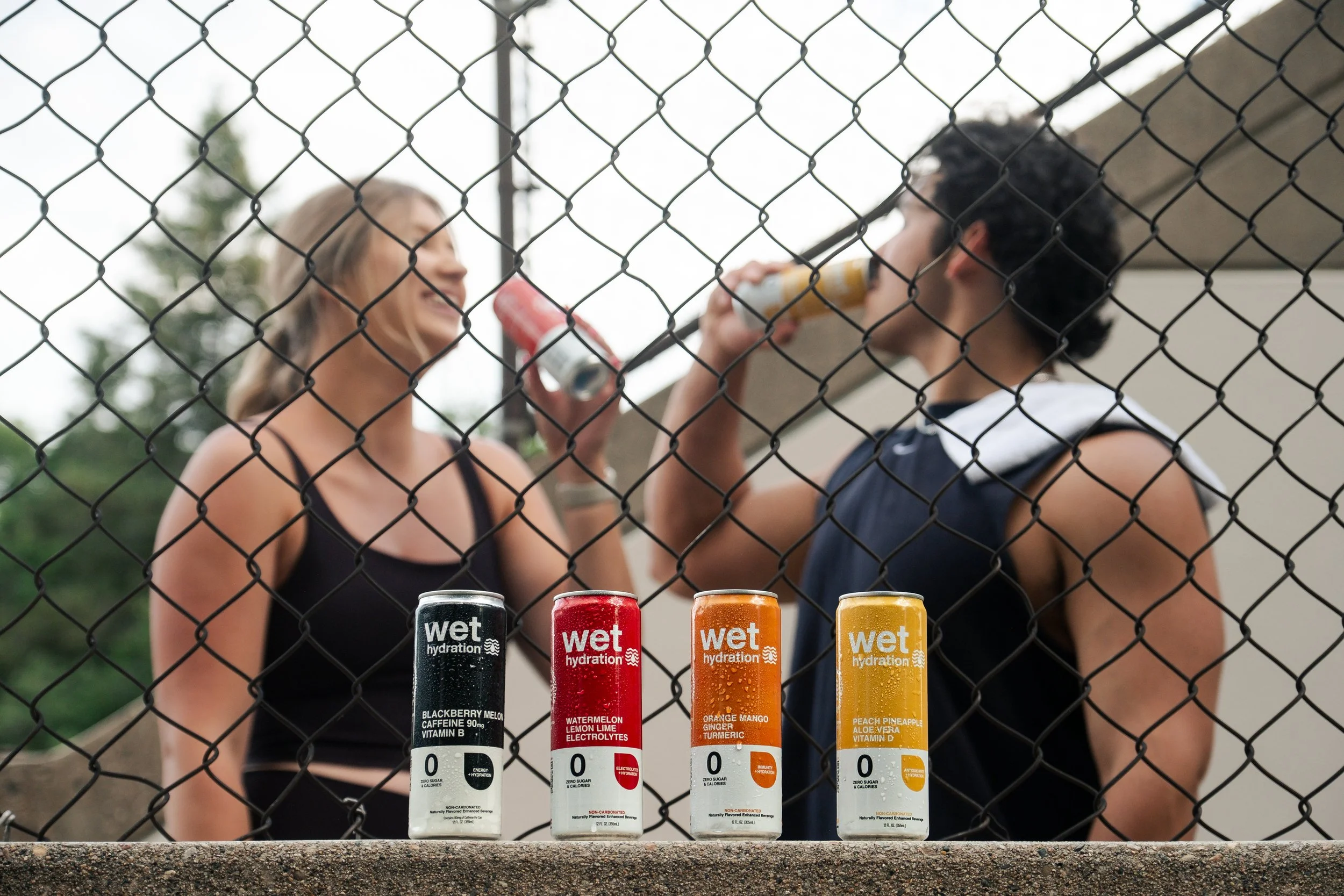 Man and woman drinking Wet Hydration