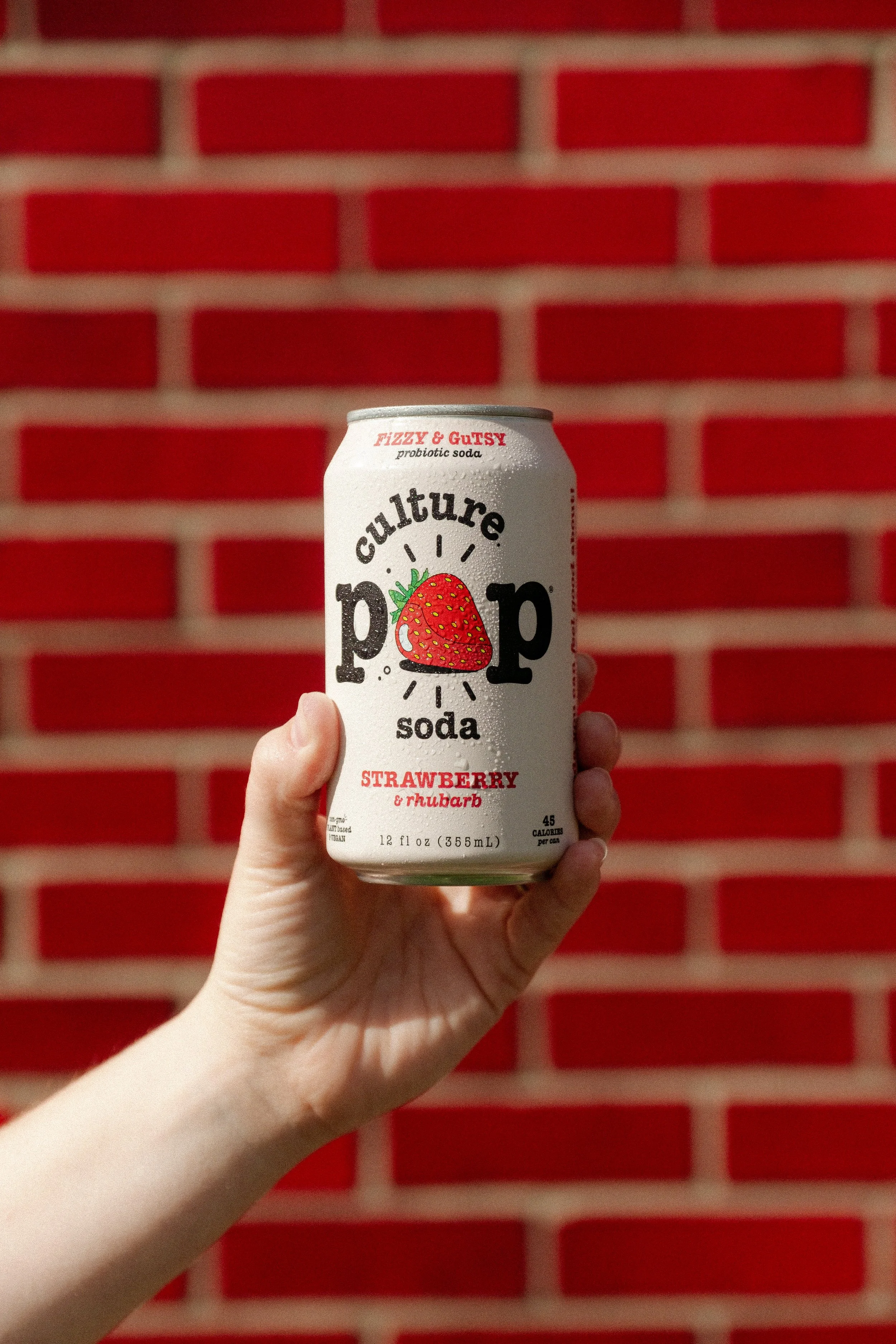 Culture Pop Soda against red brick wall
