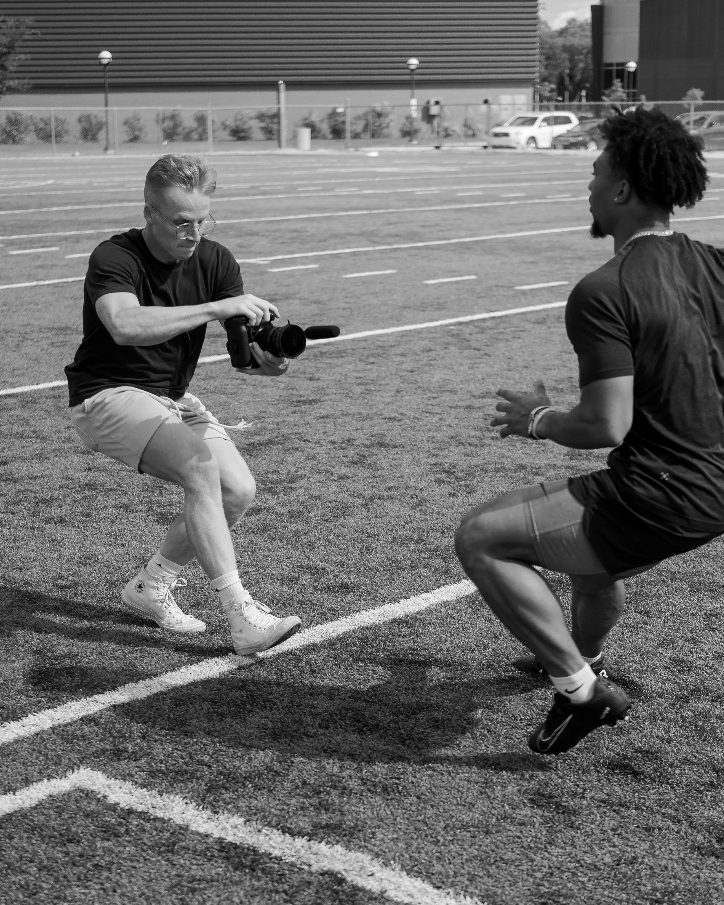 Andrew Stone holding camera filming running man.