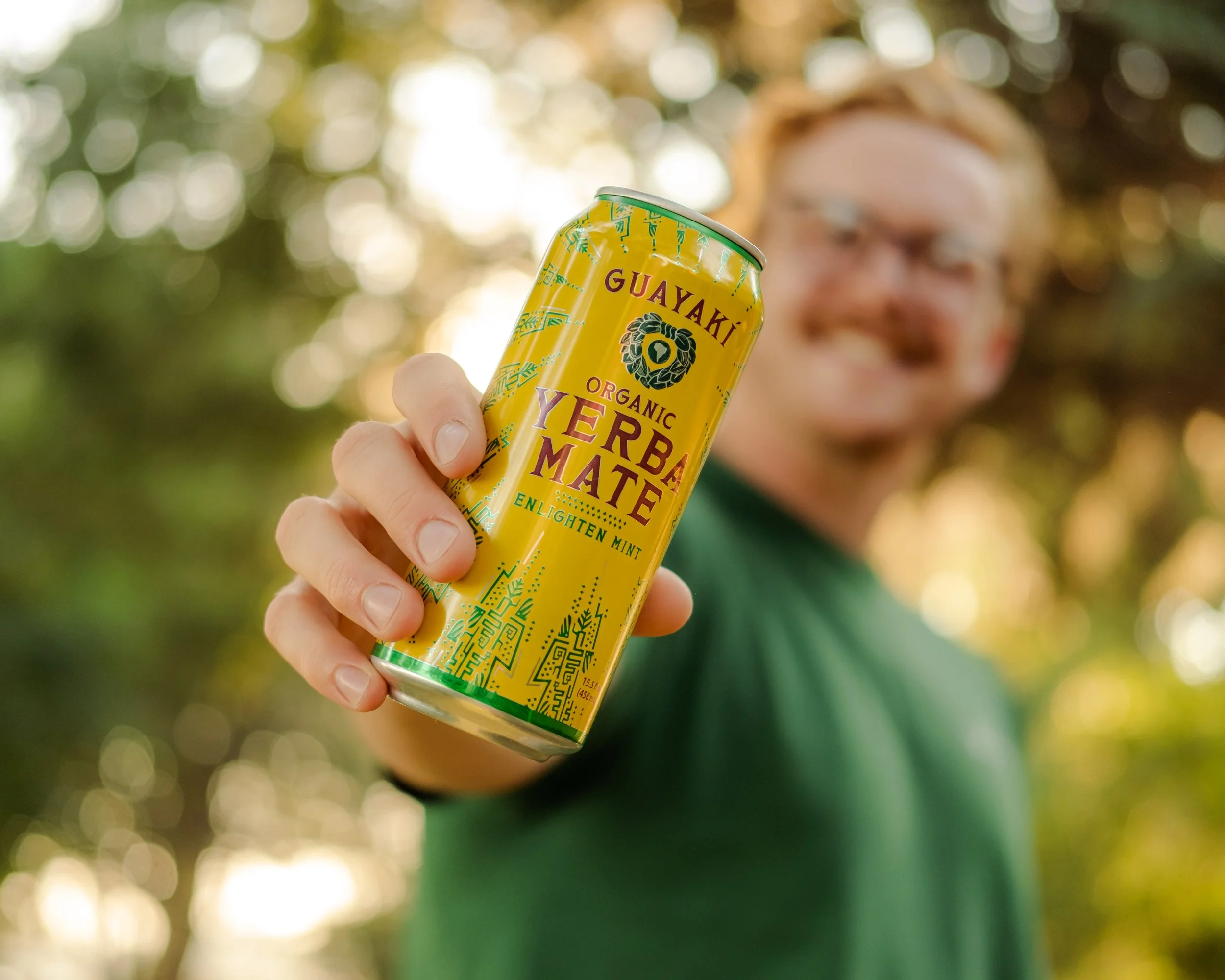 Man holding Yerba Mate in his hand outside.