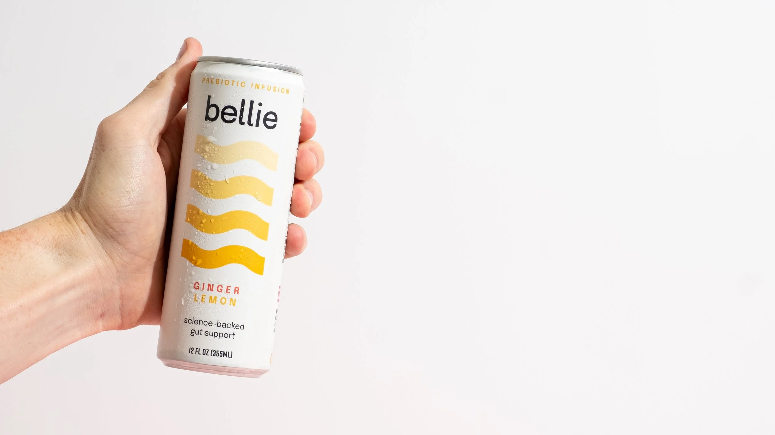 Male hand holding Bellie beverage