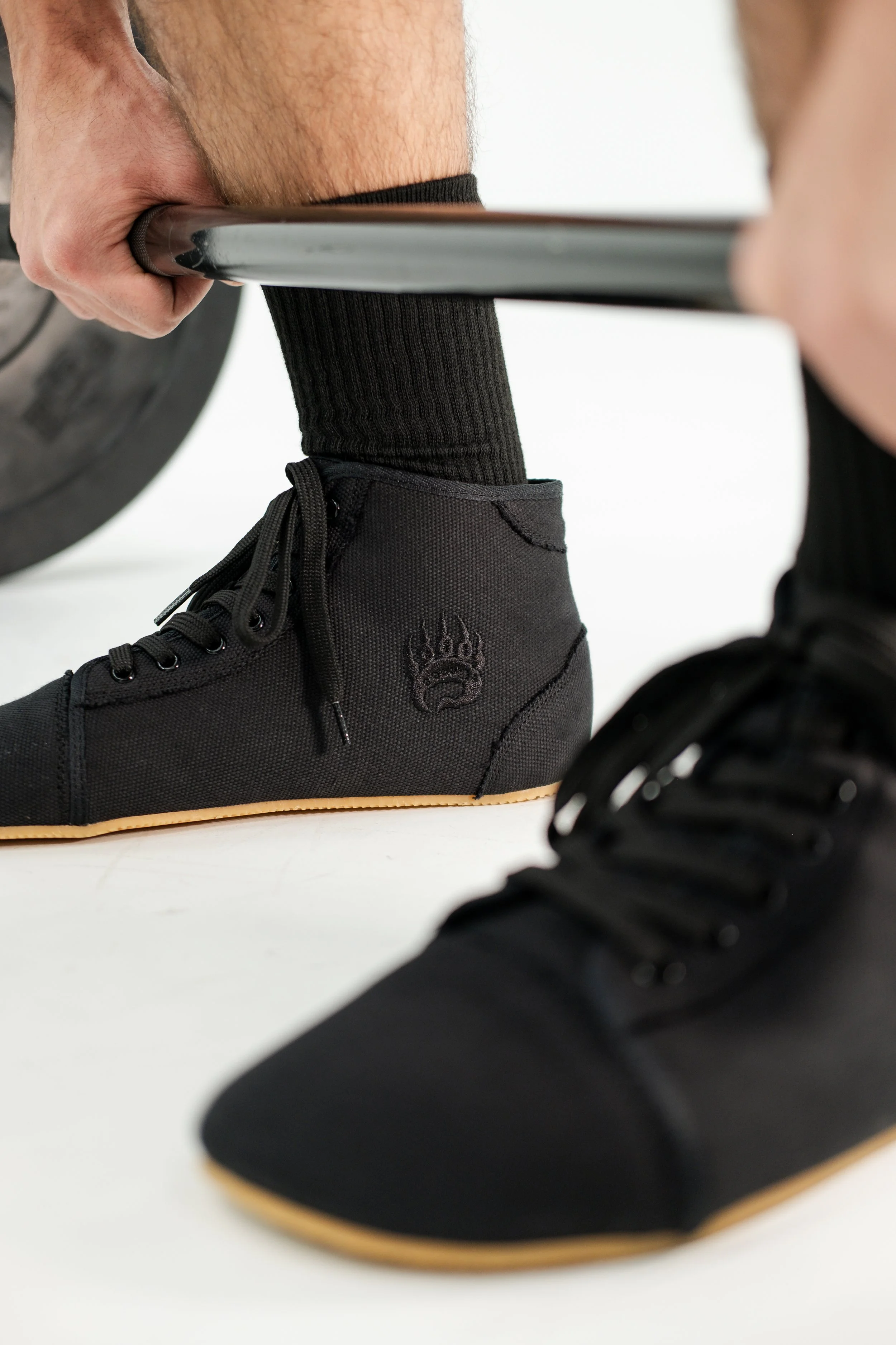 Man deadlifting wearing Bearfoot shoes.