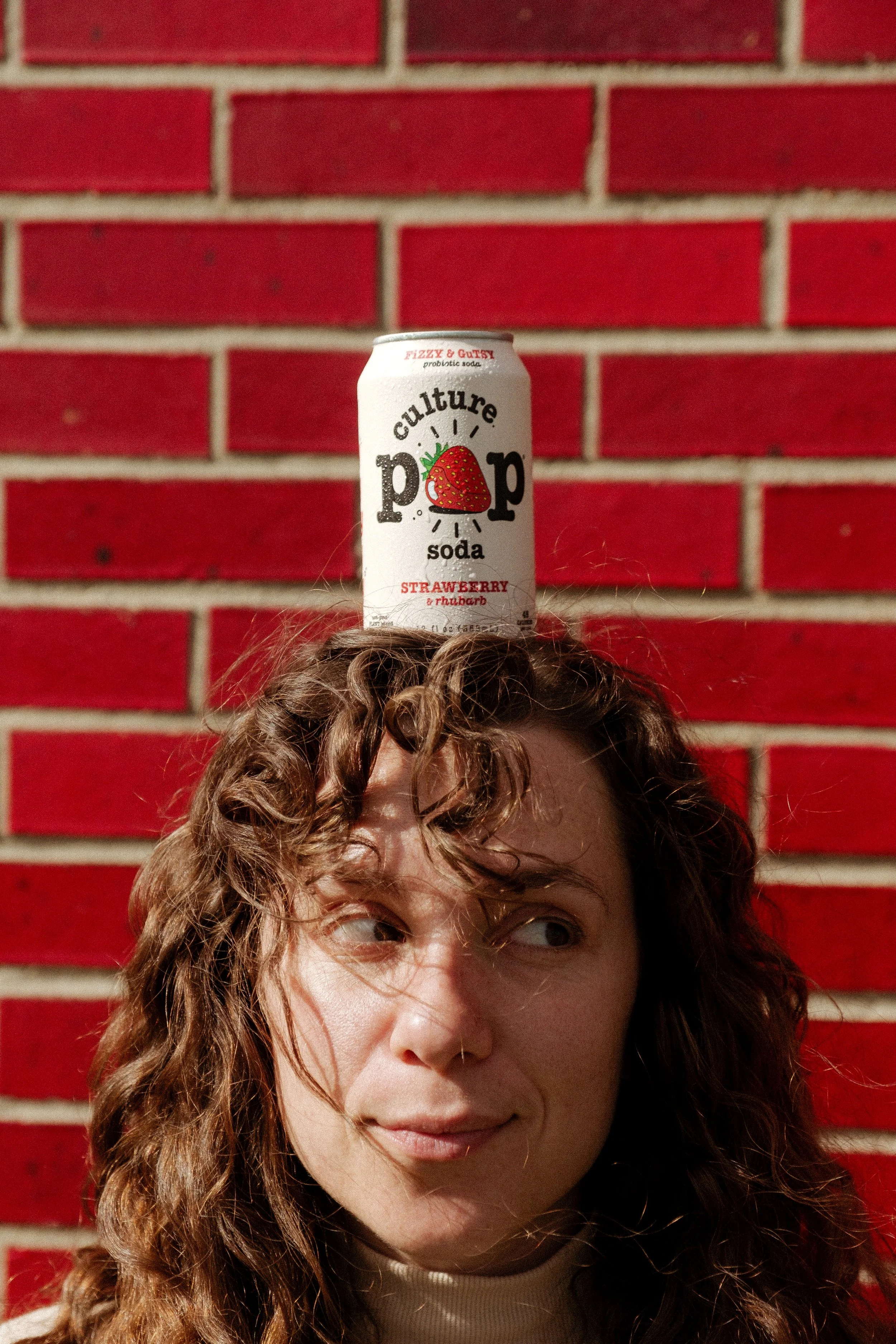 Culture Pop Soda on girl's head