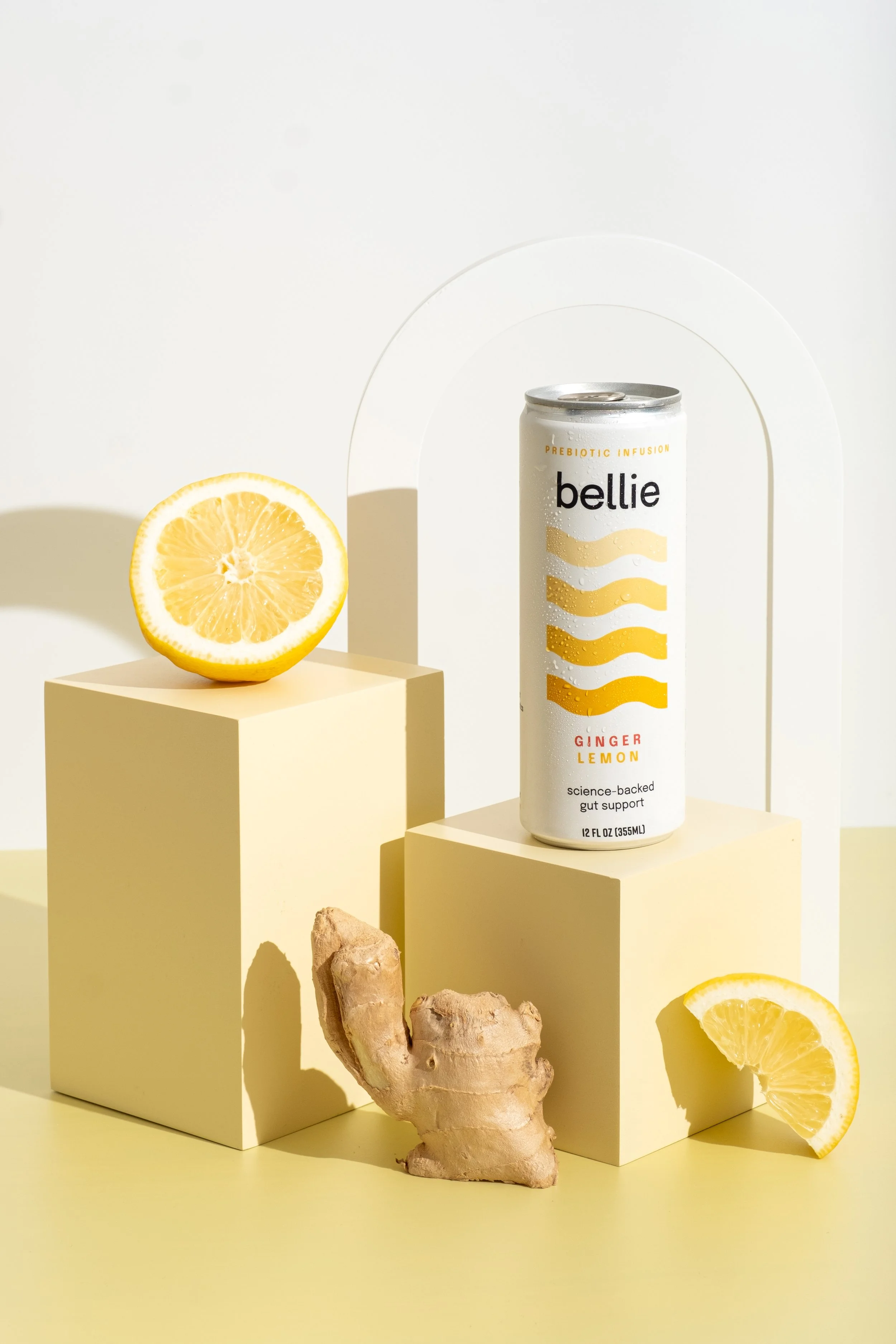 Stylized Bellie studio product photo with lemons and white arch