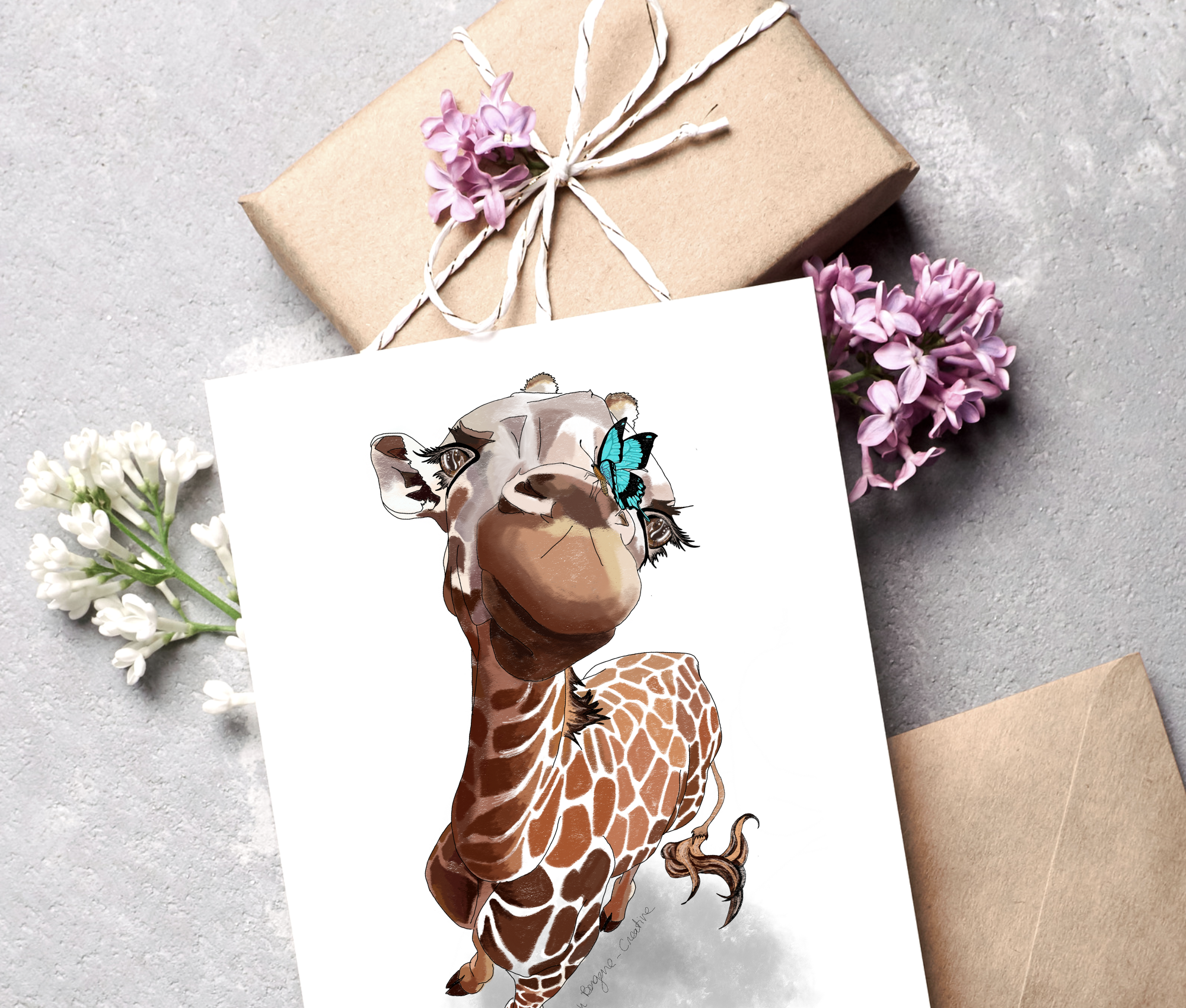 A greeting card features an illustration of a giraffe with a butterfly on its face, surrounded by flowers and wrapped gifts.