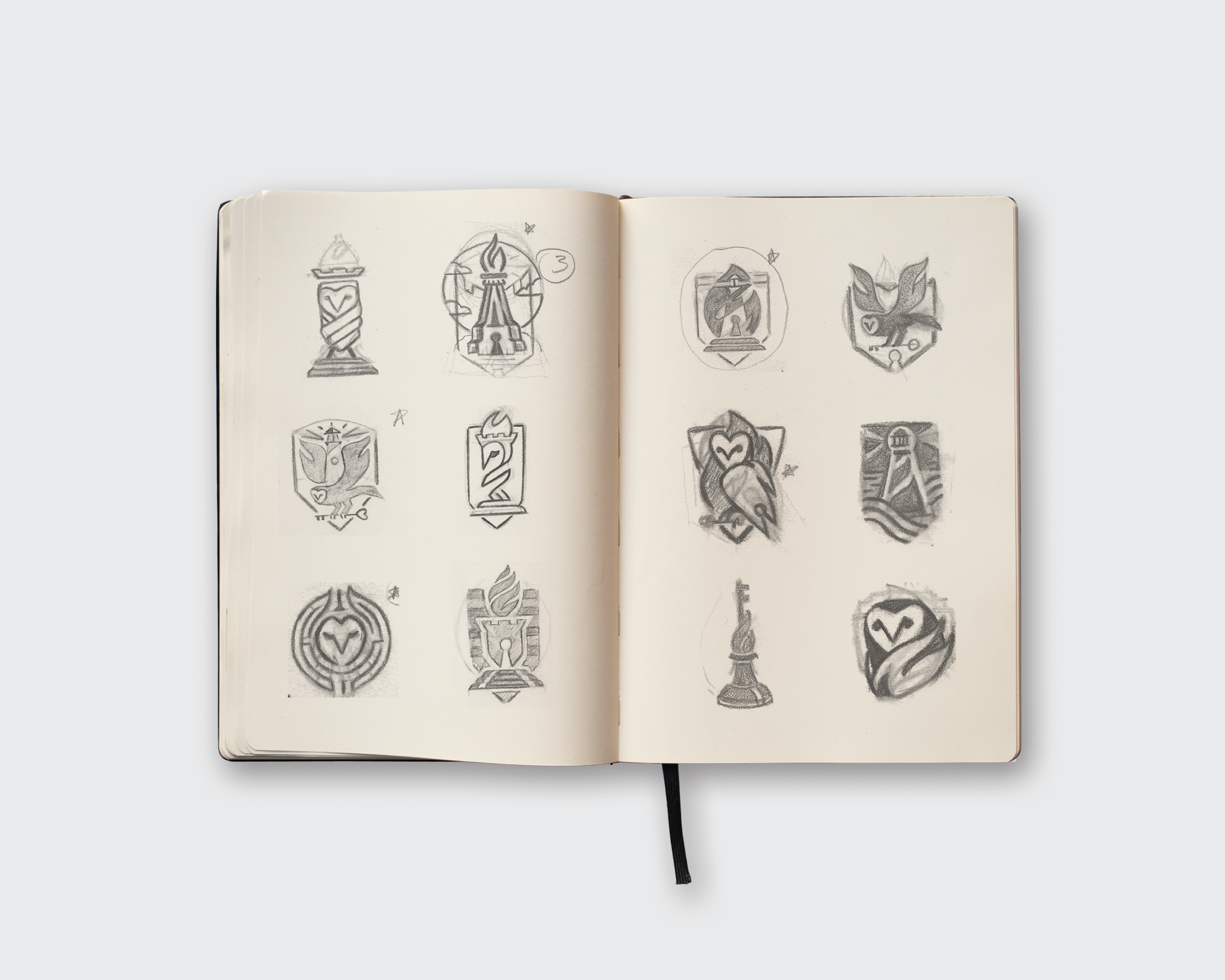 Open sketchbook showing hand-drawn concepts for the Nevada Counsel logo and brandmark development