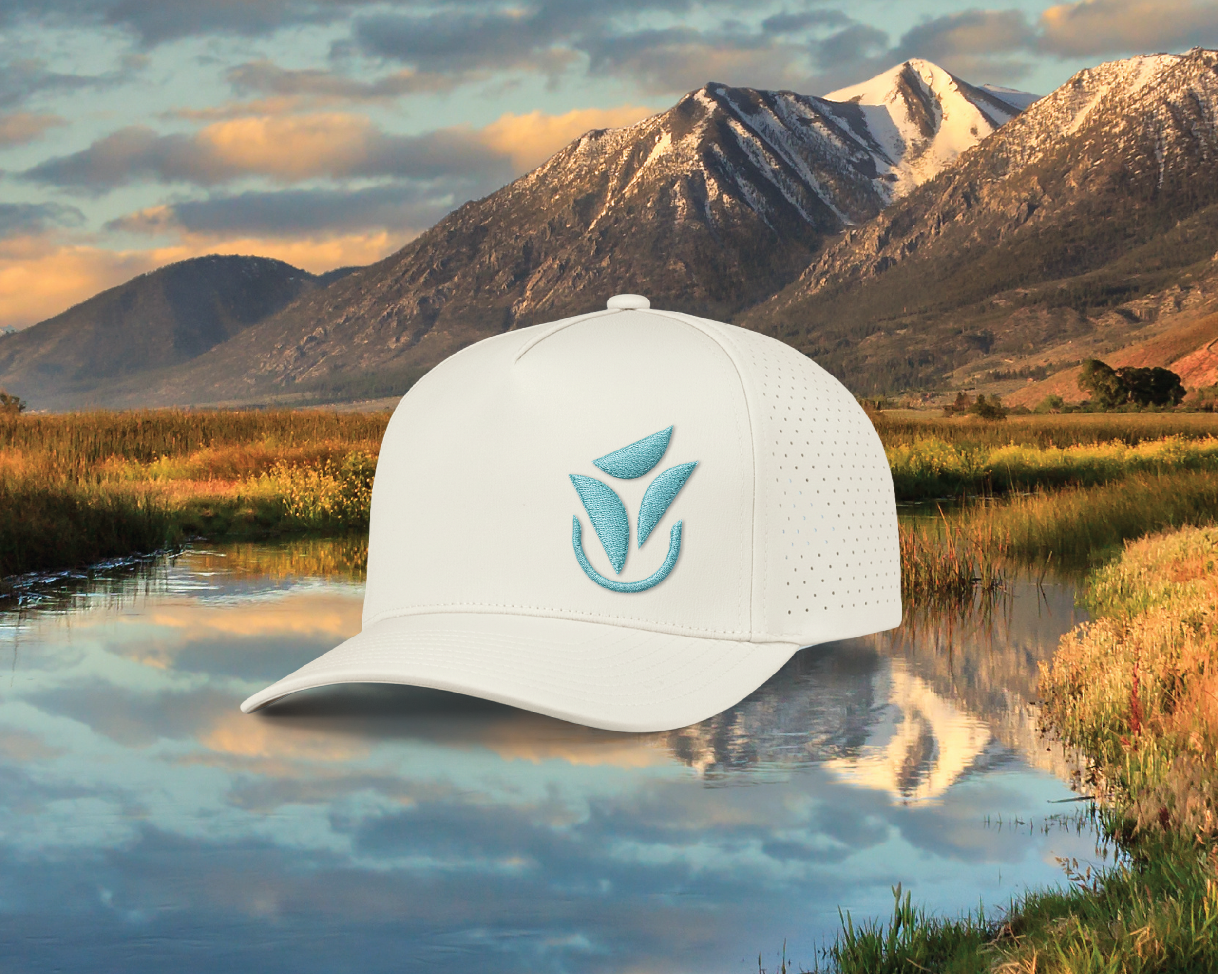 Branded white cap featuring the MCBCreative logo, demonstrating the flexibility of the visual identity across promotional merchandise.