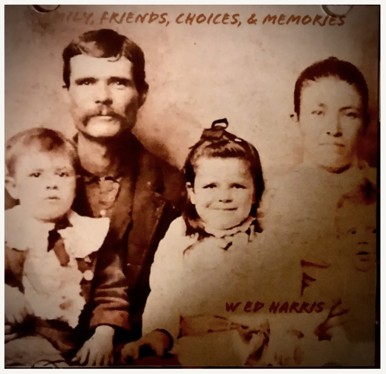 A vintage family photograph featuring a man and four children, with handwritten text at the top that reads 'Family, Friends, Choices, & Memories' and at the bottom 'Wed Harris'.