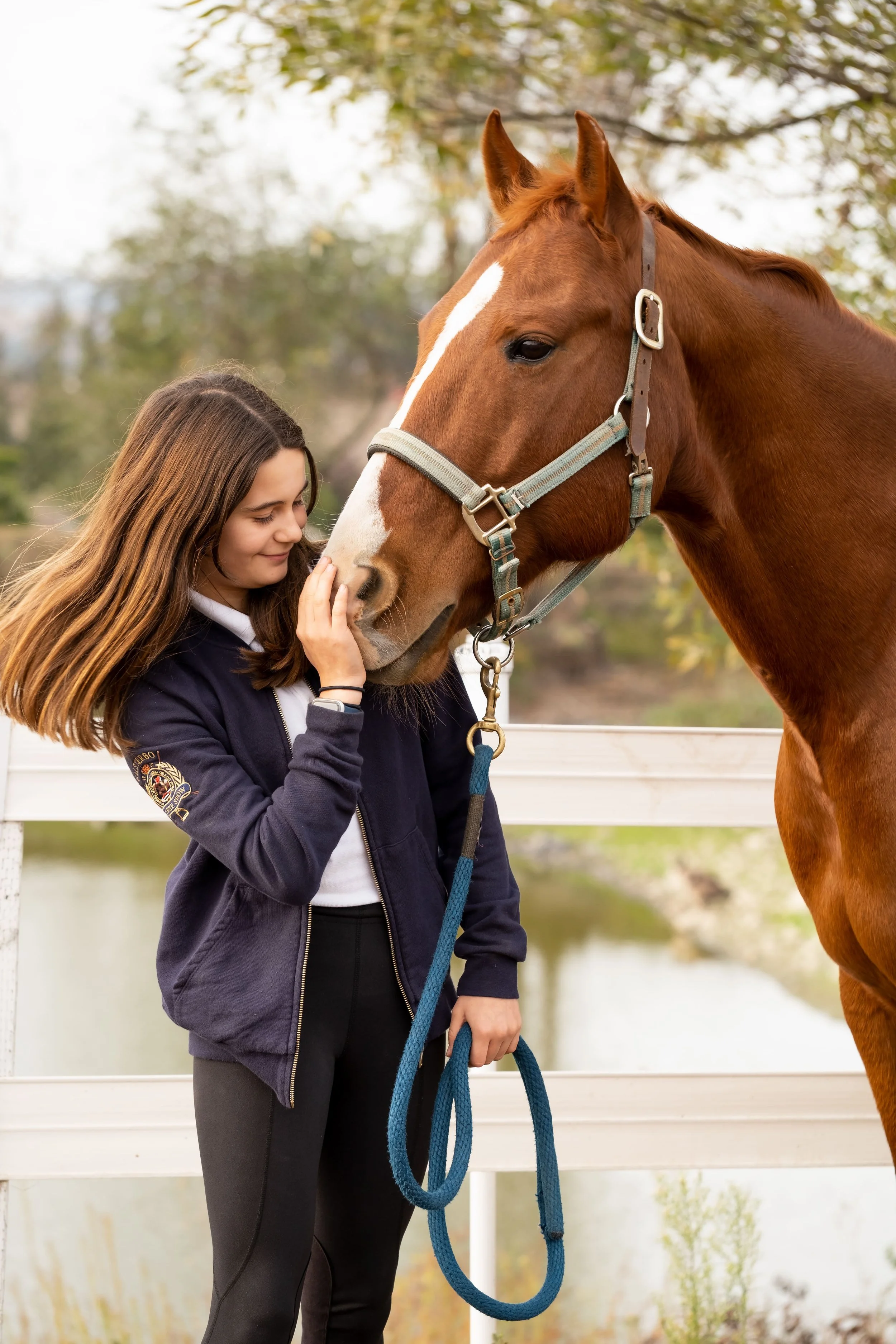 A Strides Riding Academy Legacy Program rider bonding with her horse, demonstrating hands-on horsemanship, trust, and mentorship in Petaluma, California.