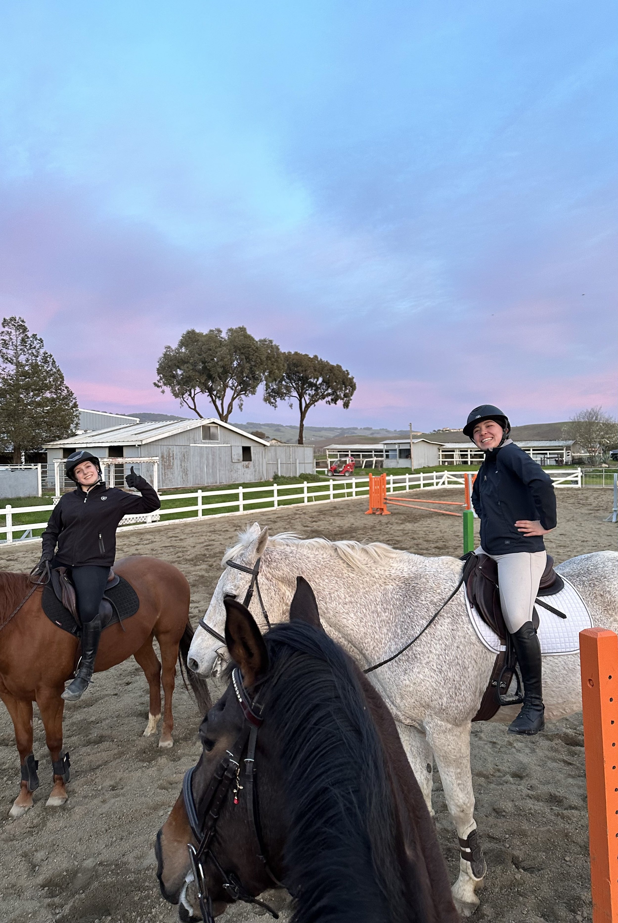 Teen riders enjoying a horseback riding lesson at Strides Riding Academy near Santa Rosa, California, during an evening session in Sonoma County.