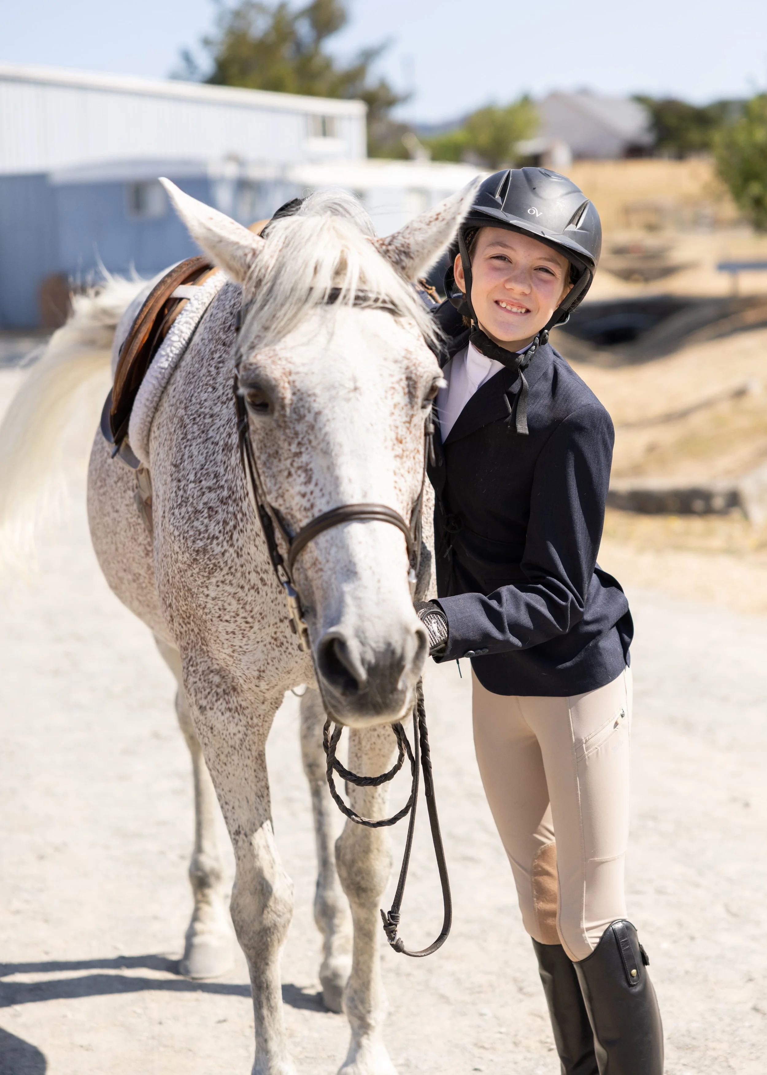 A Strides Riding Academy Legacy Program youth rider confidently leading her horse, reflecting growth, responsibility, and horsemanship in Petaluma, California.