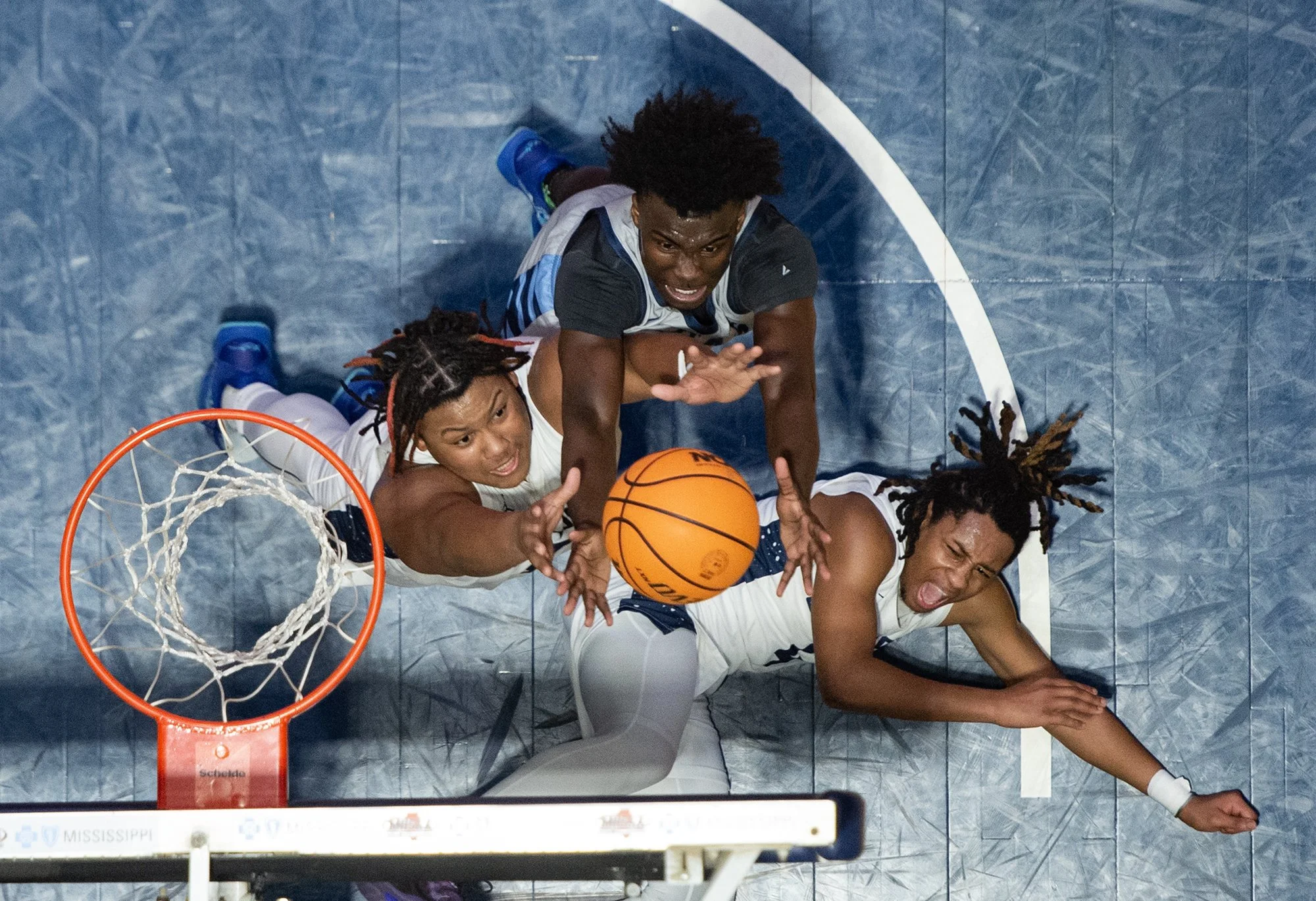  Olive Branch's Tommy Callicut (30) and Ridgeland's Phil Nelson (20) vie for the ball before tripping over Olive Branch's James Hill (4) during the MHSAA Class 6A state championship game at the Mississippi Coliseum in Jackson, Miss., on March 1, 2025