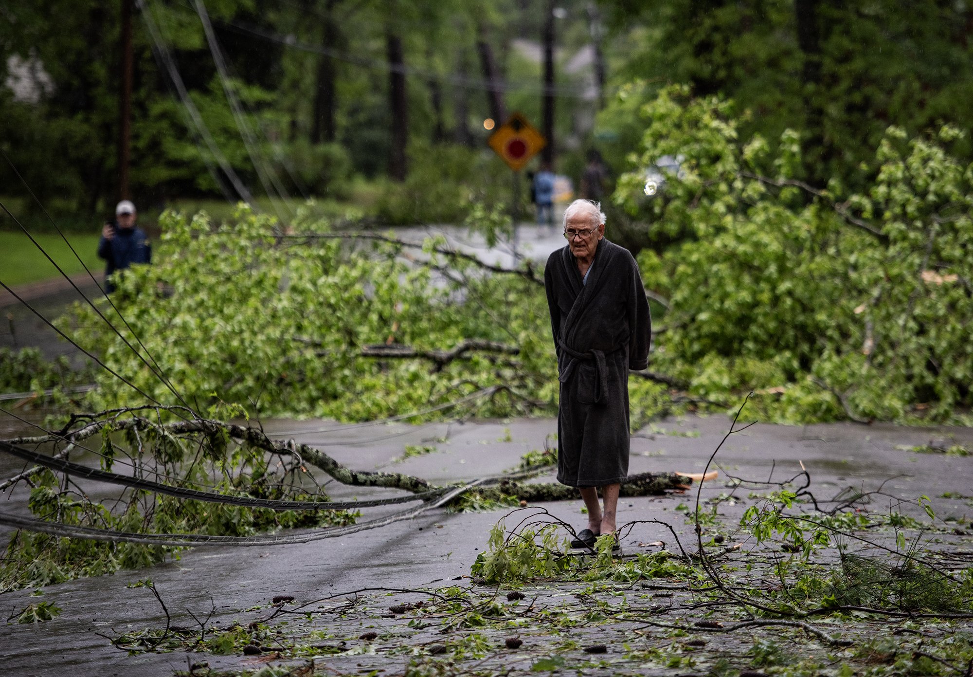  Bill Johnson looks at the downed trees and power lines from the storm the night before on Northampton Drive in Jackson, Miss., on April 10, 2024. “Sounded like a freight train going over,” Johnson said. [Clarion Ledger] 