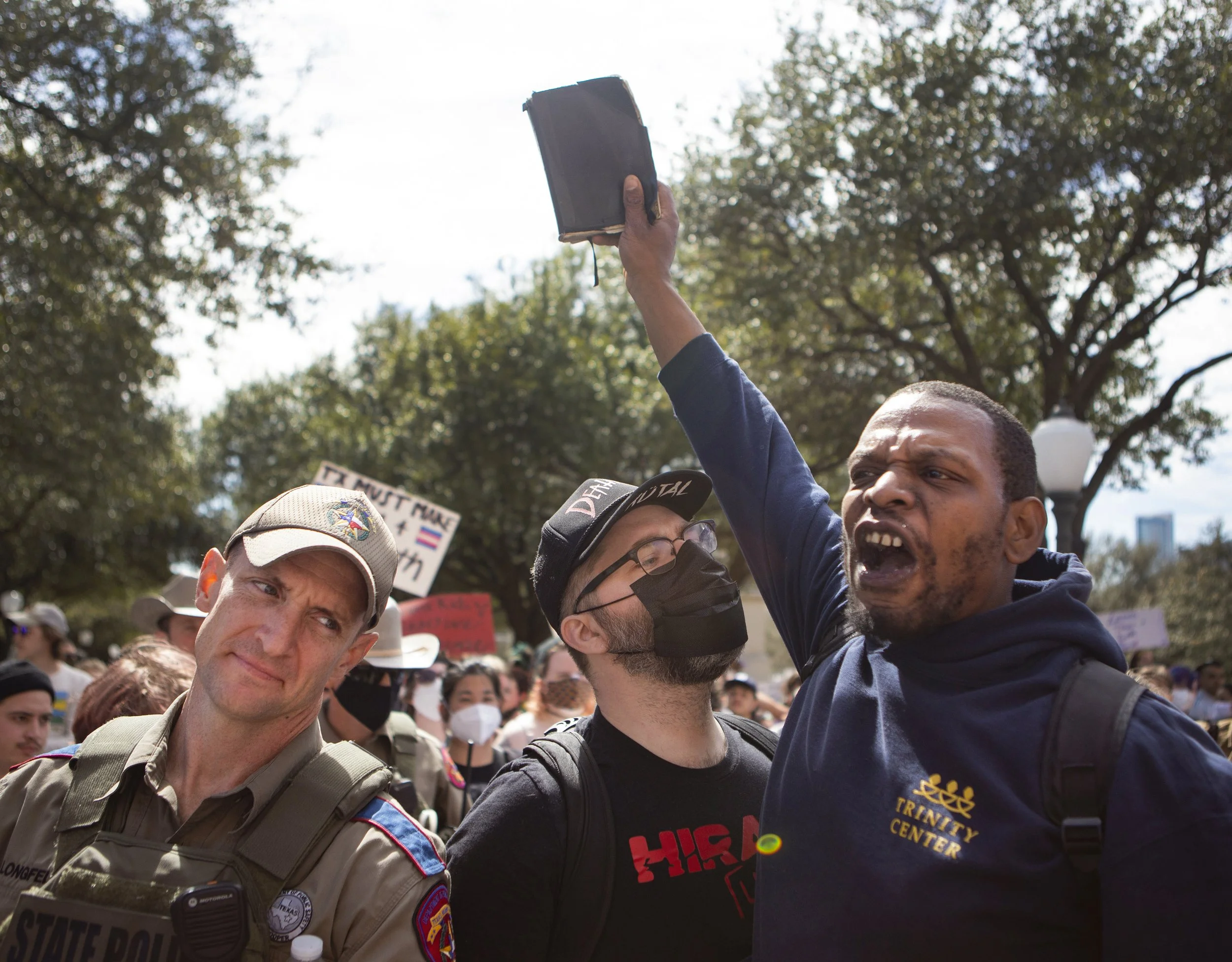  A counter protester yells and holds up a Bible in the middle of a protest for transgender kids' rights in front of the Texas Capitol in Austin, Texas, on March 1, 2022. 